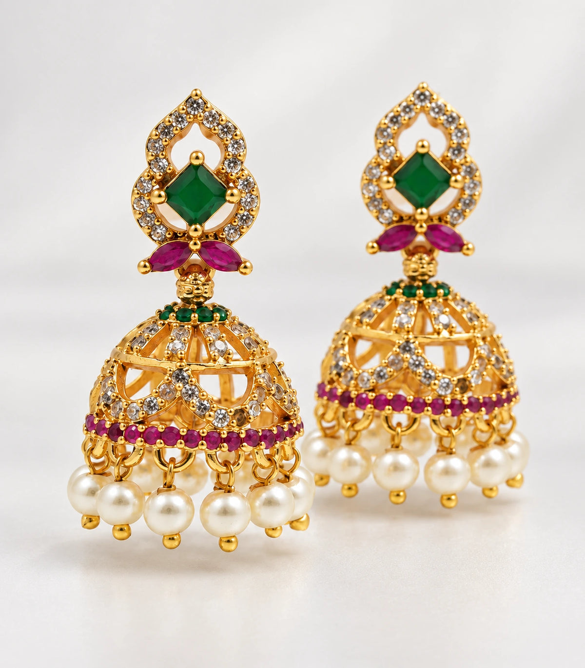 Complete matching pair of gold-tone green and magenta openwork jhumka earrings with white pearl-style fringe