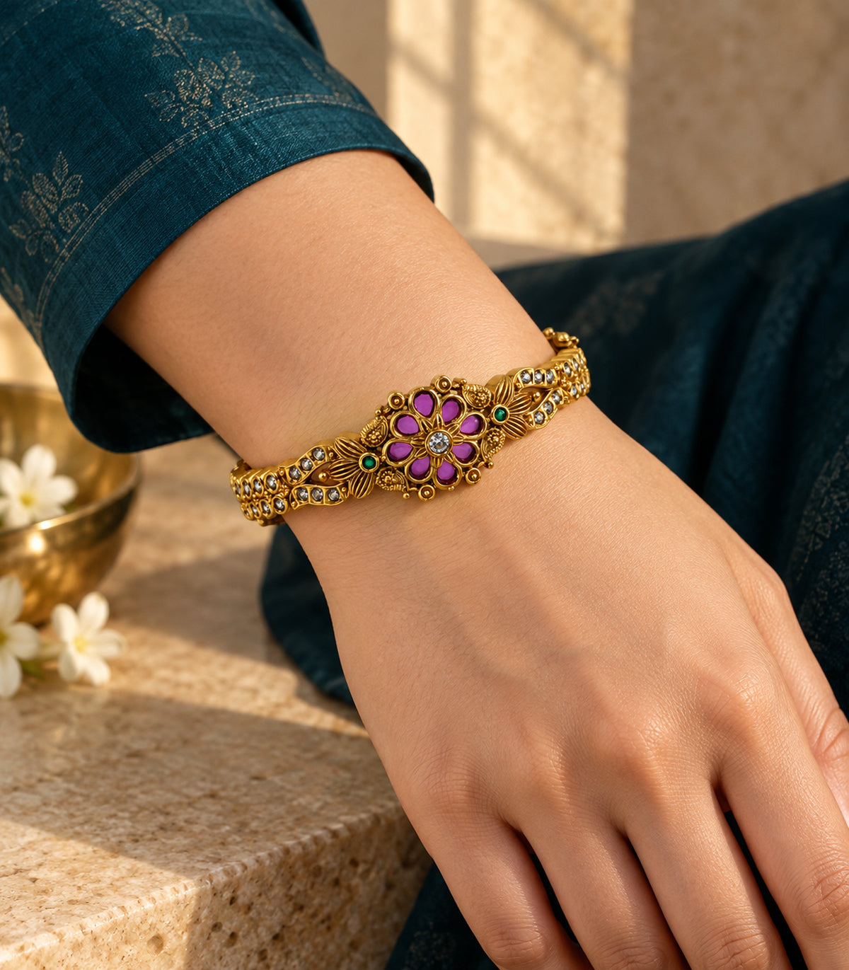 Gold-tone magenta and green floral bangle in an editorial wrist composition