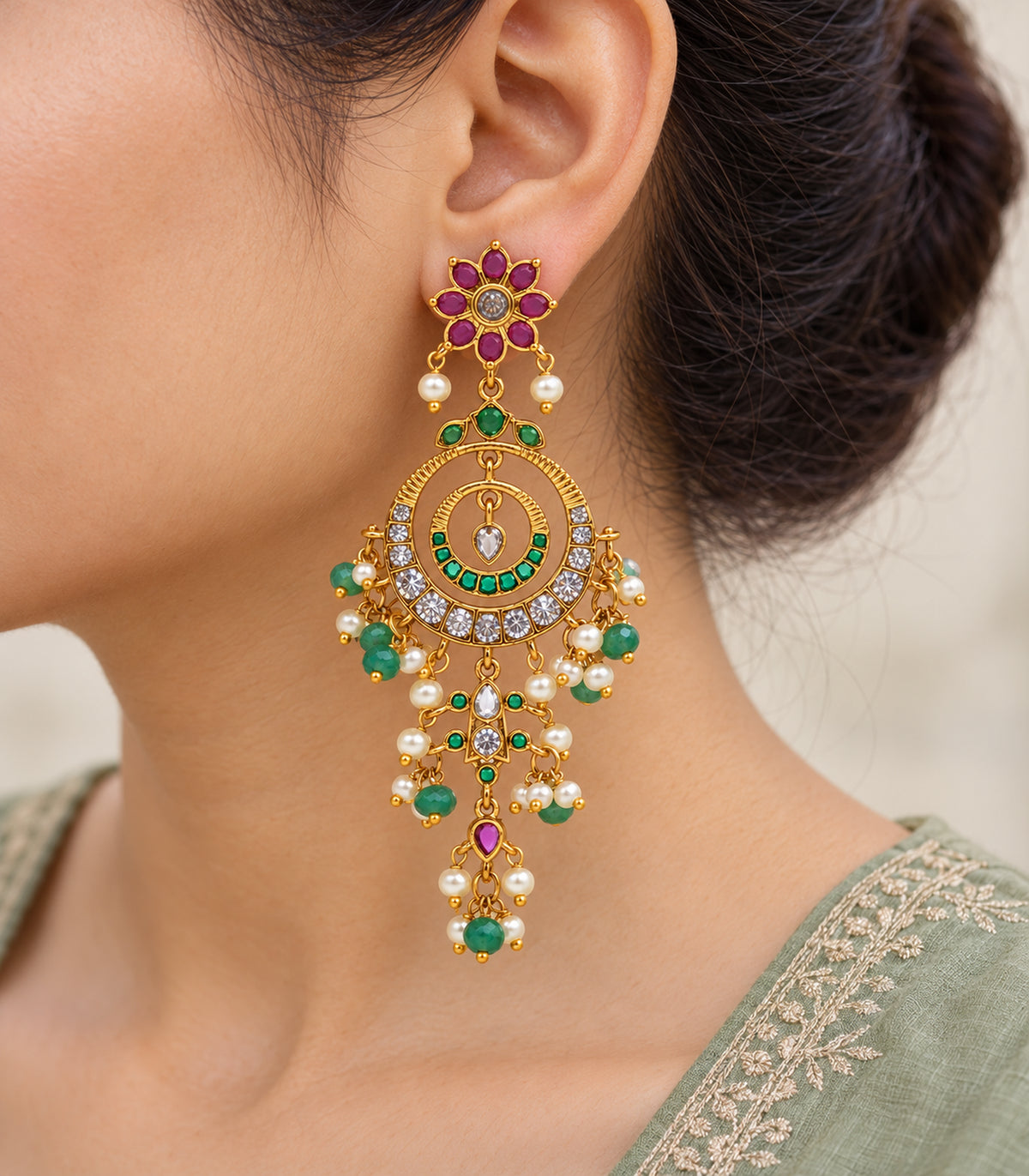 Close-up of the magenta flower, nested hoops and bead fringe of the worn chandelier earring