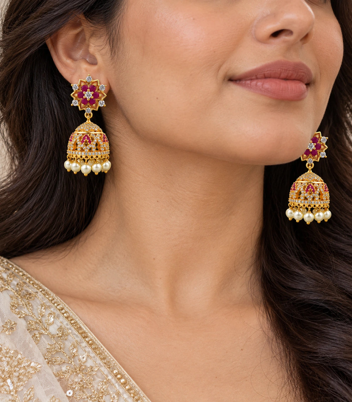 Gold Magenta Floral Crystal Pearl Jhumka Earrings — close-up of floral studs and pearl-fringed bells worn