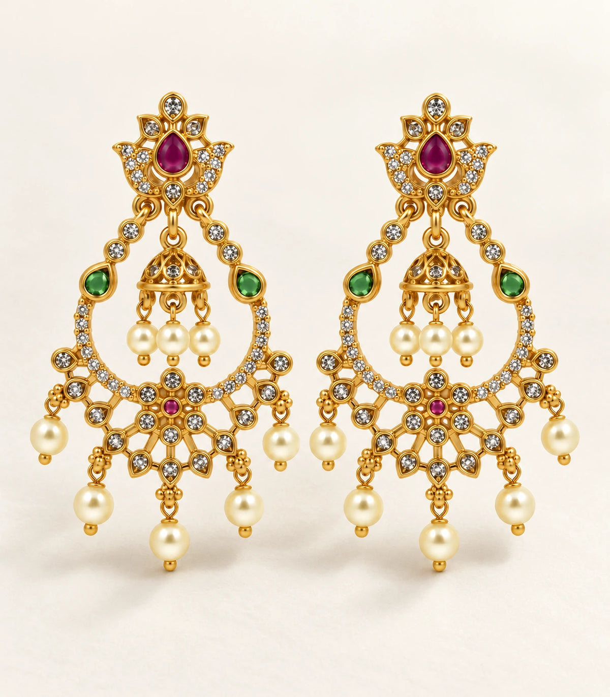 Complete magenta and green chandbali earring pair with bell centres on a light neutral surface