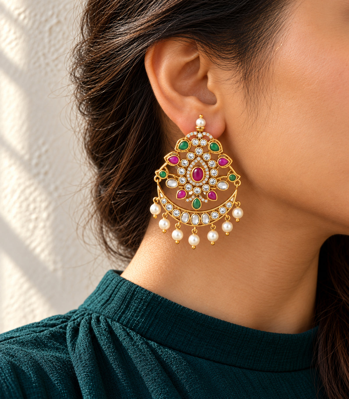 Editorial single-ear view of the gold magenta and green pearl-style chandbali earring