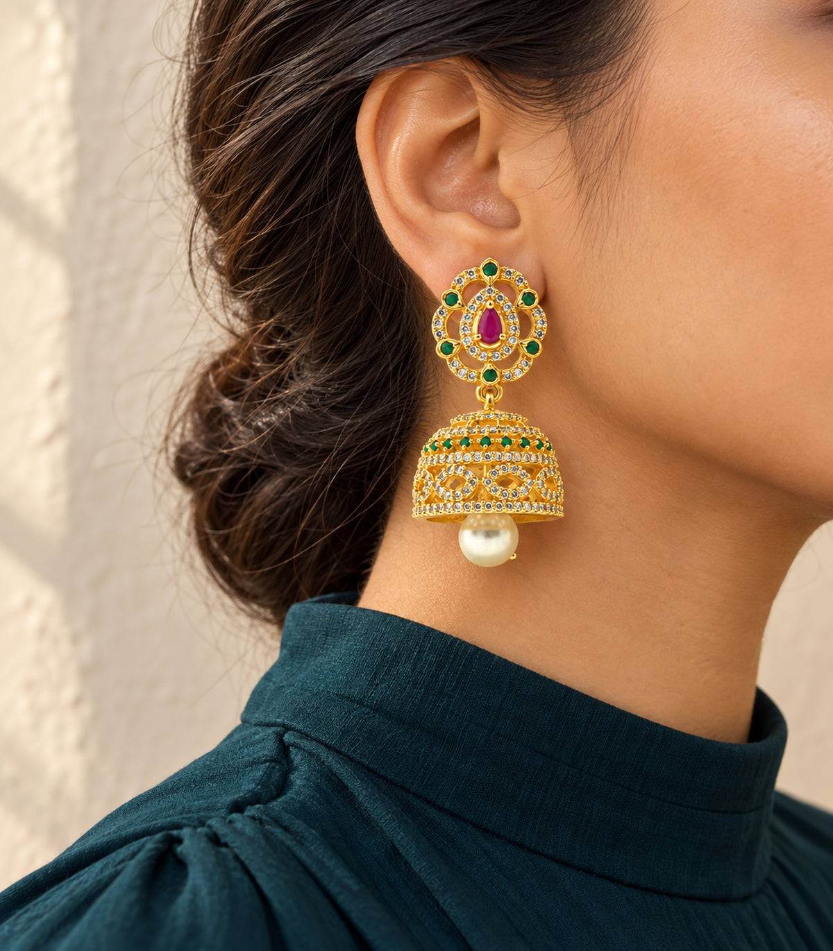 Gold-tone magenta and green teardrop pearl jhumka earring in editorial worn styling