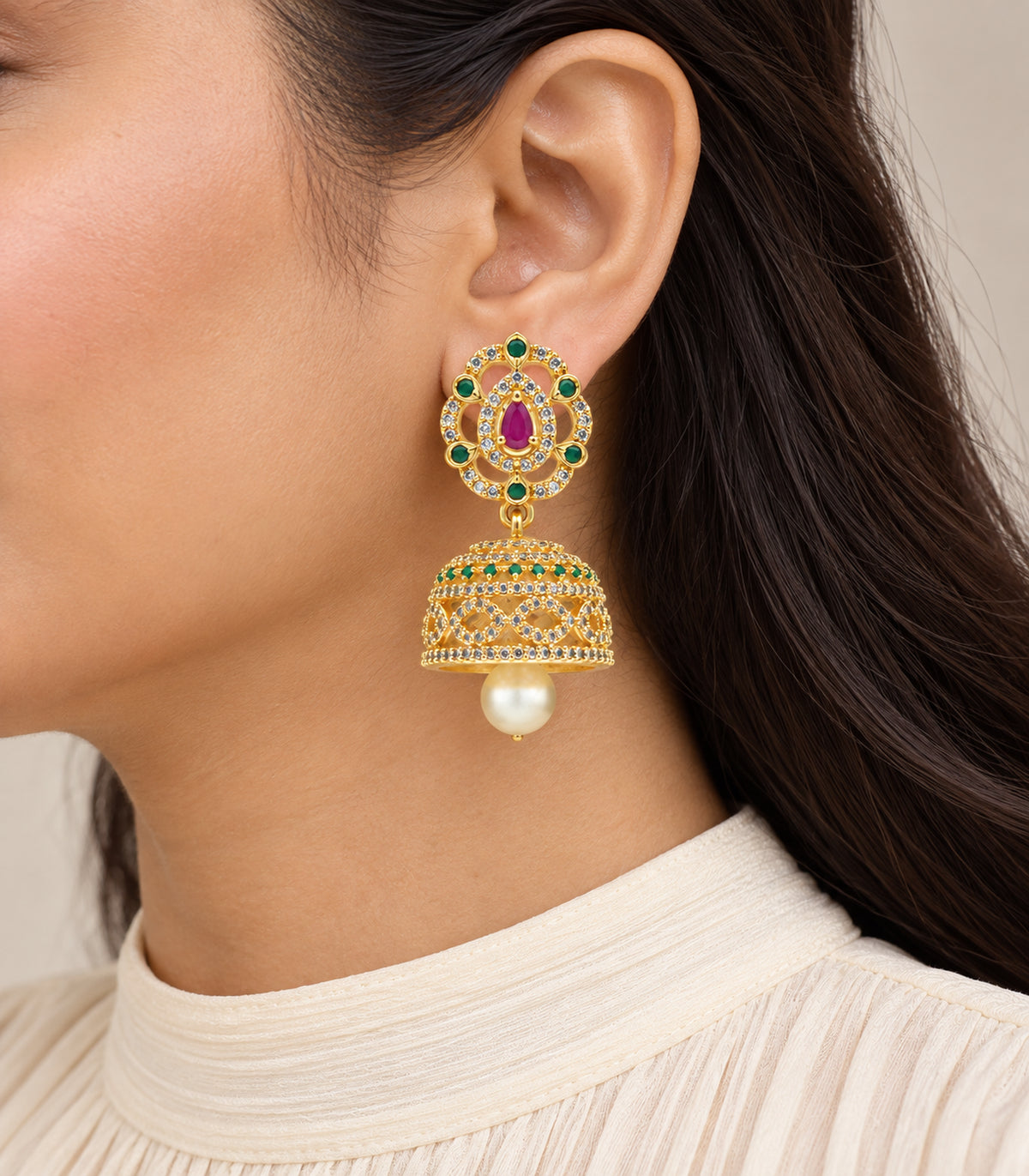 Single earring worn, showing the magenta and green teardrop top, domed bell and pearl drop