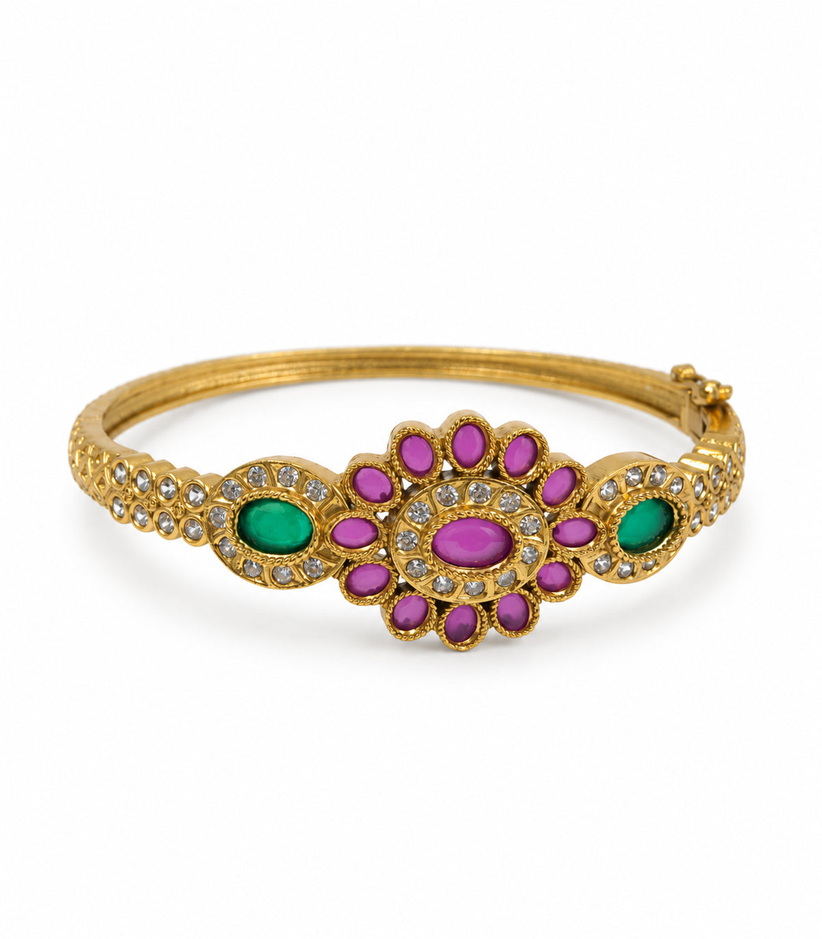 Gold-tone bangle with magenta oval flower, two green oval halos and clear-stone arms on white