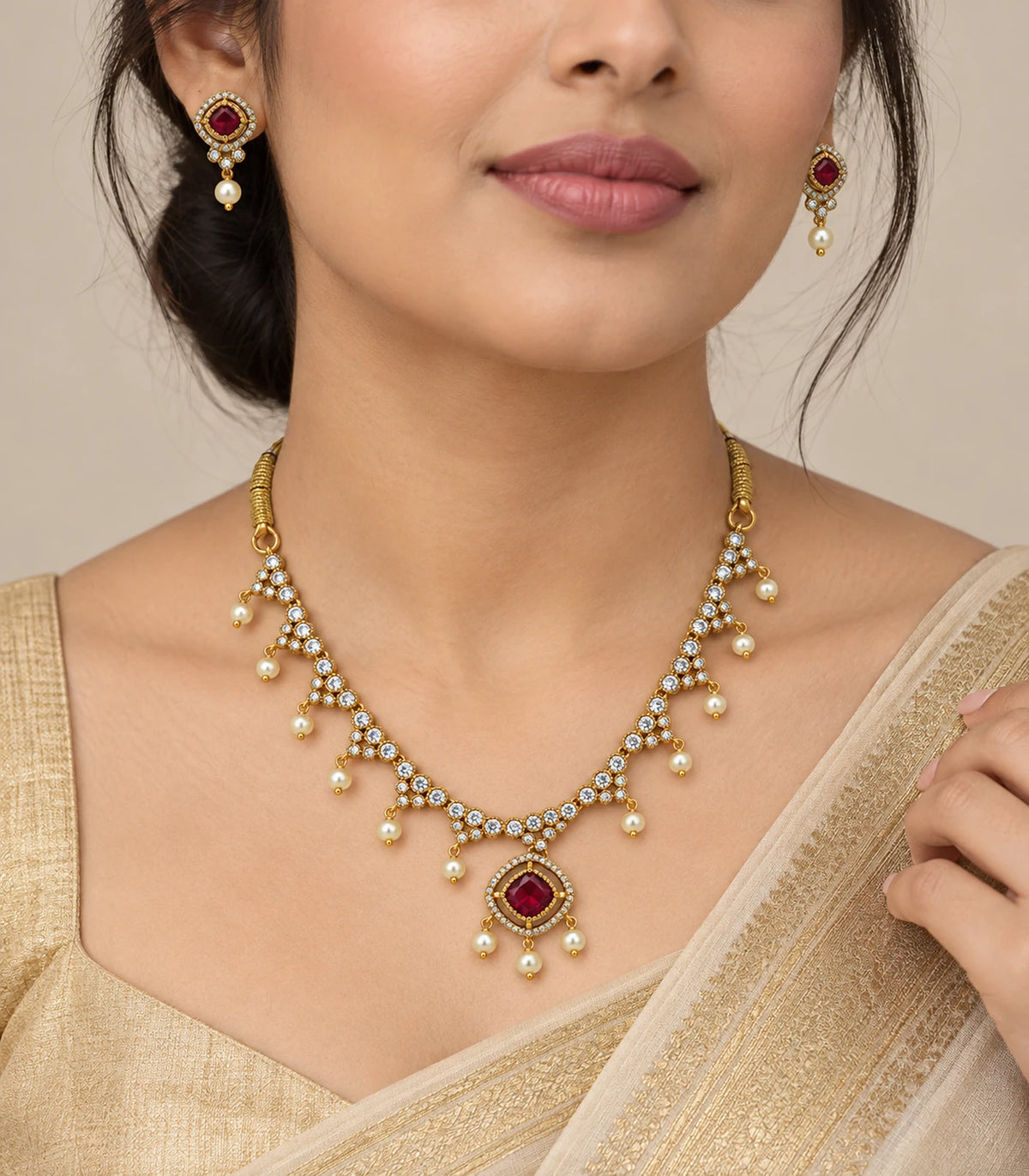 Gold-tone magenta square necklace set with pearl fringe worn with matching earrings