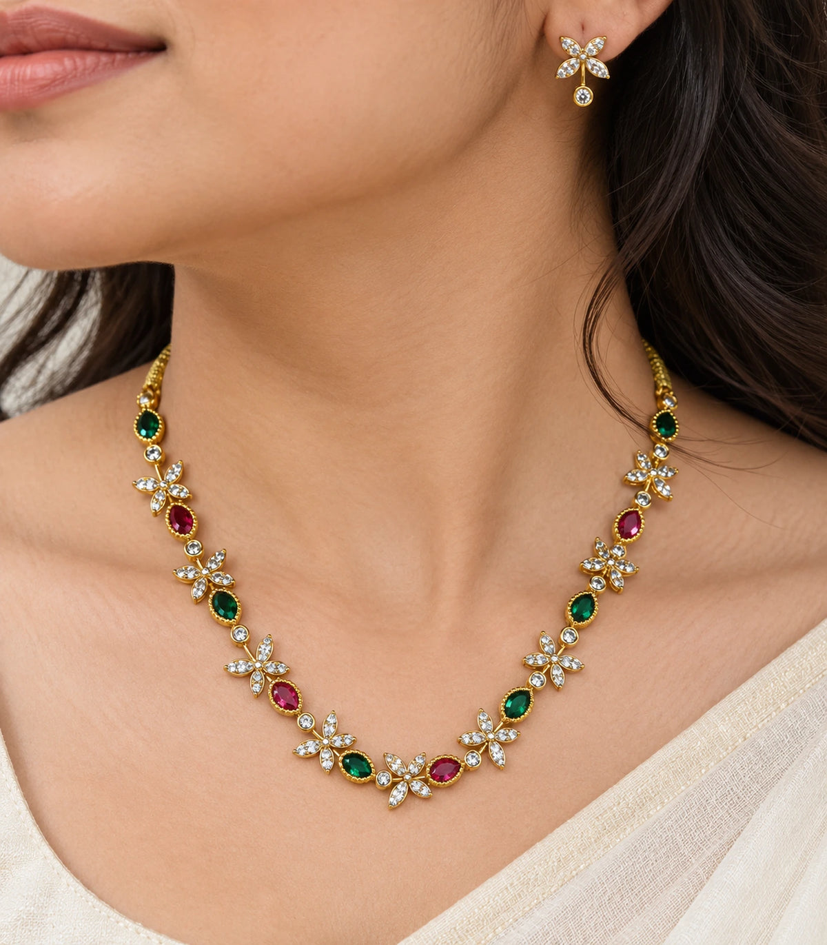 Close view of the gold multicolor floral necklace and a matching earring worn