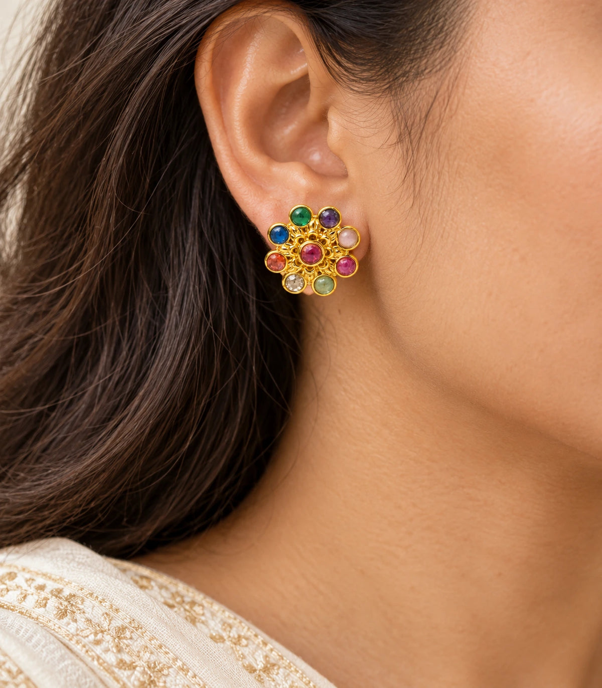 Gold-tone multicolour flower stud earring shown in a worn closeup