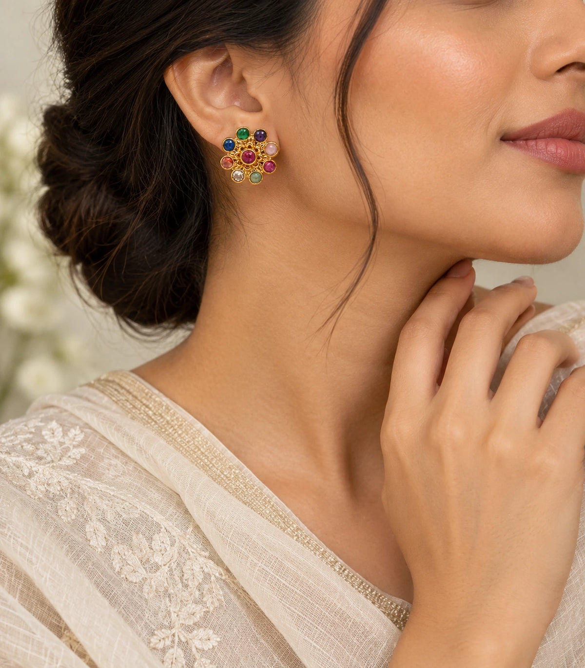 Gold-tone multicolour flower stud earring worn in an editorial portrait