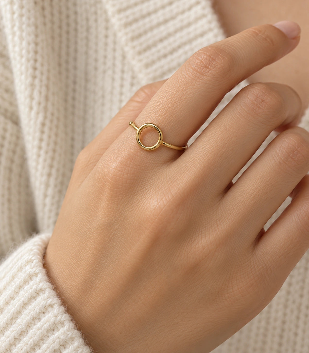 Gold Open Circle Minimal Ring worn naturally on a finger with cream knit styling