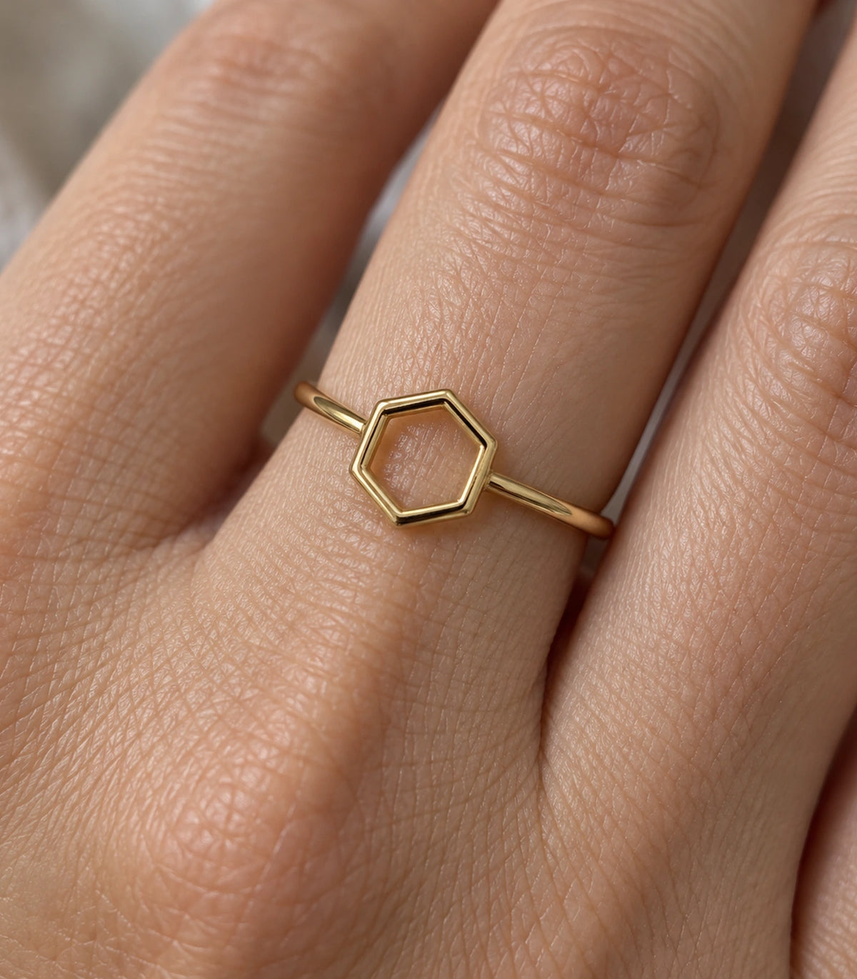 Close view of the Gold Open Hexagon Minimal Ring worn on a finger