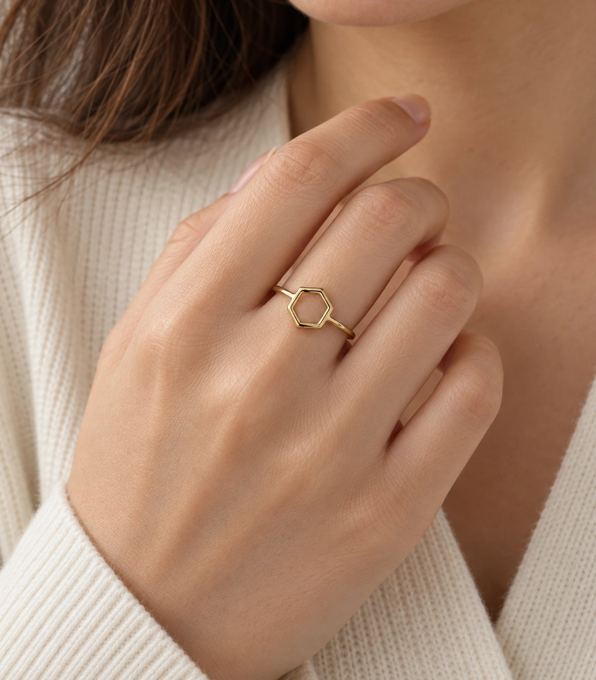 Gold Open Hexagon Minimal Ring worn with a cream outfit in an editorial hand pose