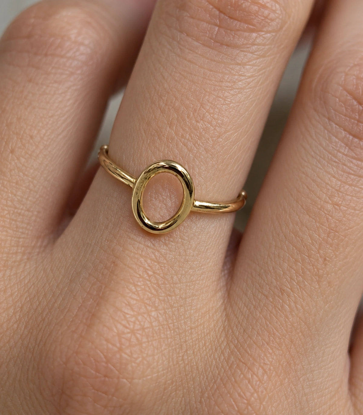 Close view of Gold Open Oval Minimal Ring worn on a finger