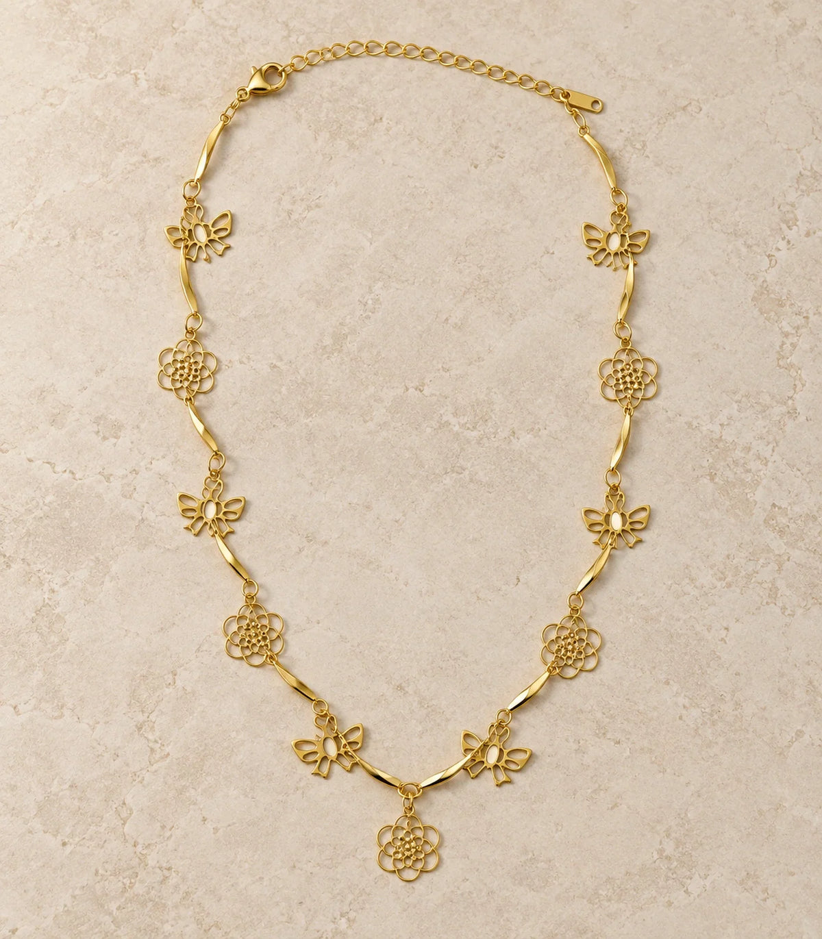 Gold Openwork Butterfly and Flower Station Anklet — editorial flatlay