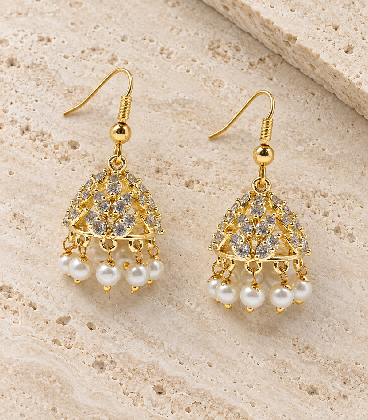 JIMIKI Openwork Crystal Leaf Pearl Hook Jhumka Earrings in Gold - editorial flatlay #color_gold