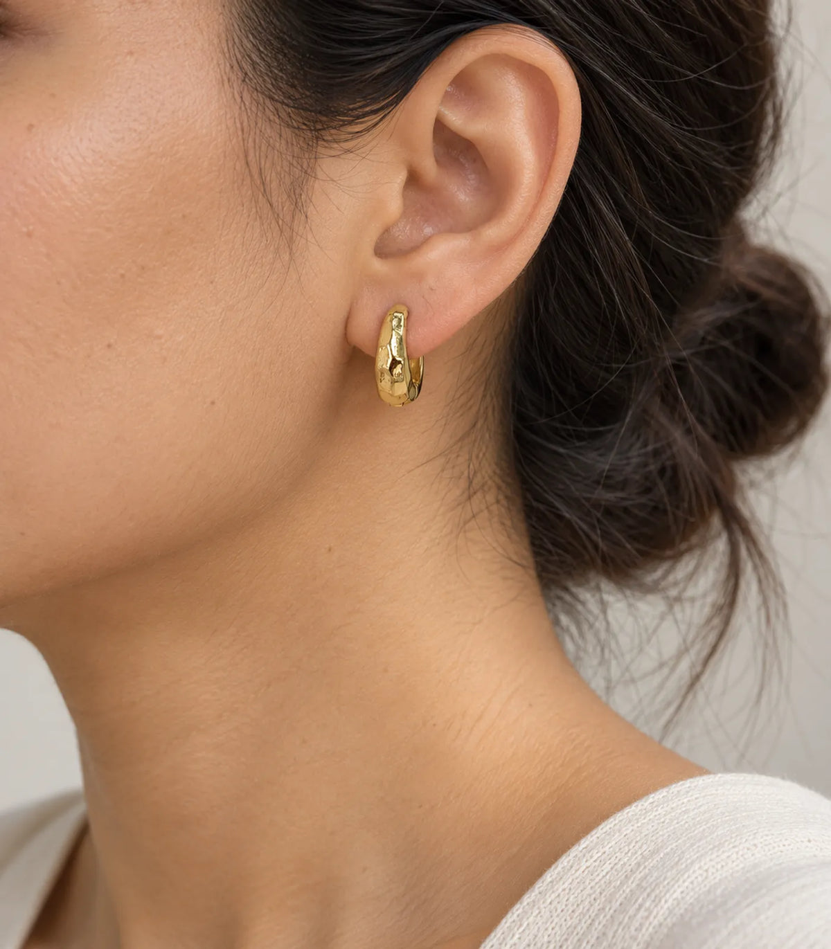JIMIKI Gold Organic Hammered Huggie Earrings — worn styling view #color_gold-tone