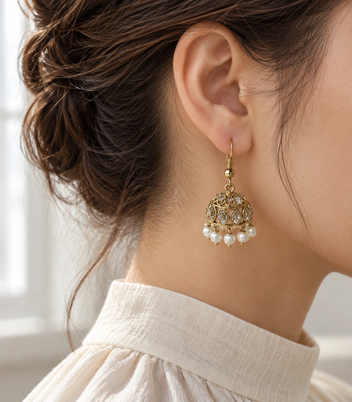 JIMIKI Gold Oval Crystal Pearl Hook Jhumka Earrings - Gold earring in a styled model view #color_gold
