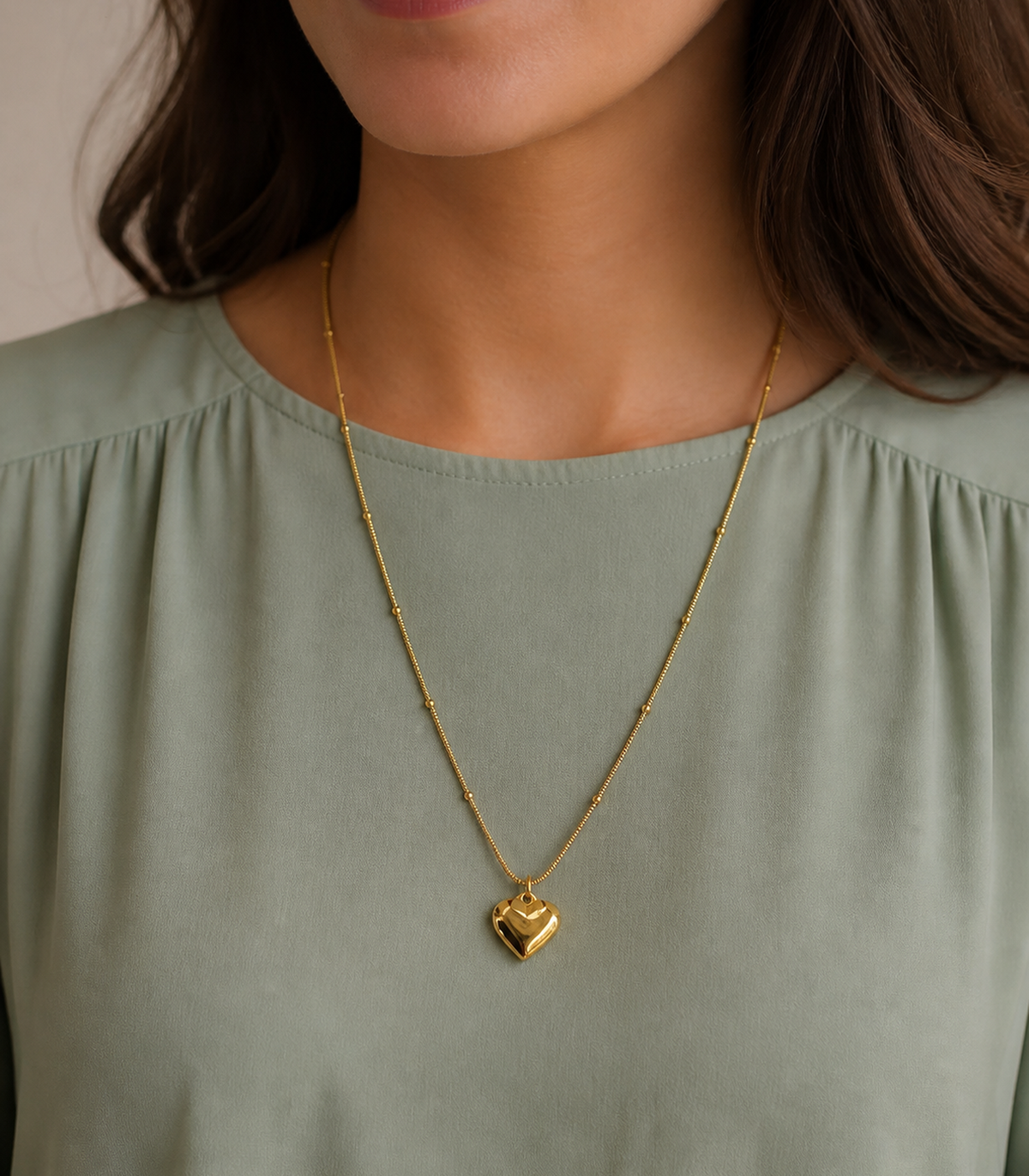 Gold Puffed Heart Bead Necklace styled on a model