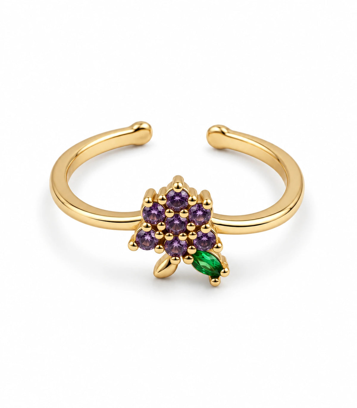 Gold-tone open ring with seven purple flower stones, a green leaf and gold-tone leaf on white