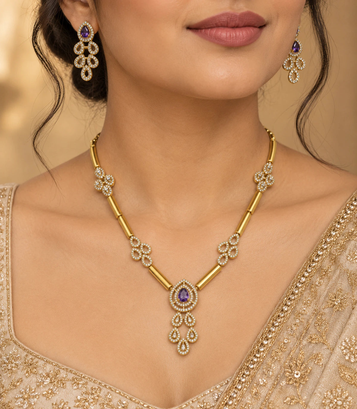 Gold-tone purple teardrop necklace set and matching earrings worn with a gold outfit