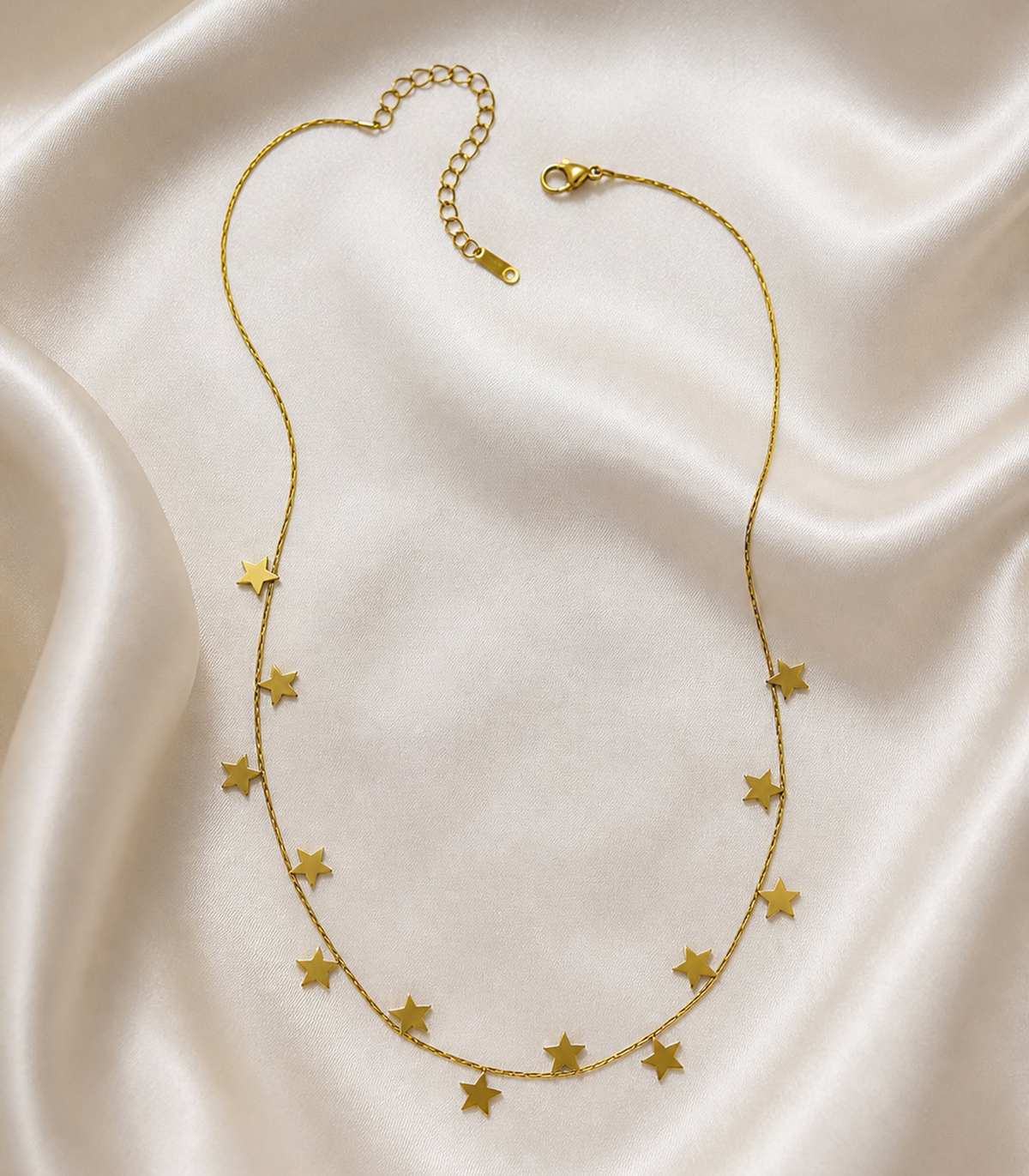 Gold Star Charm Necklace styled in a flat lay