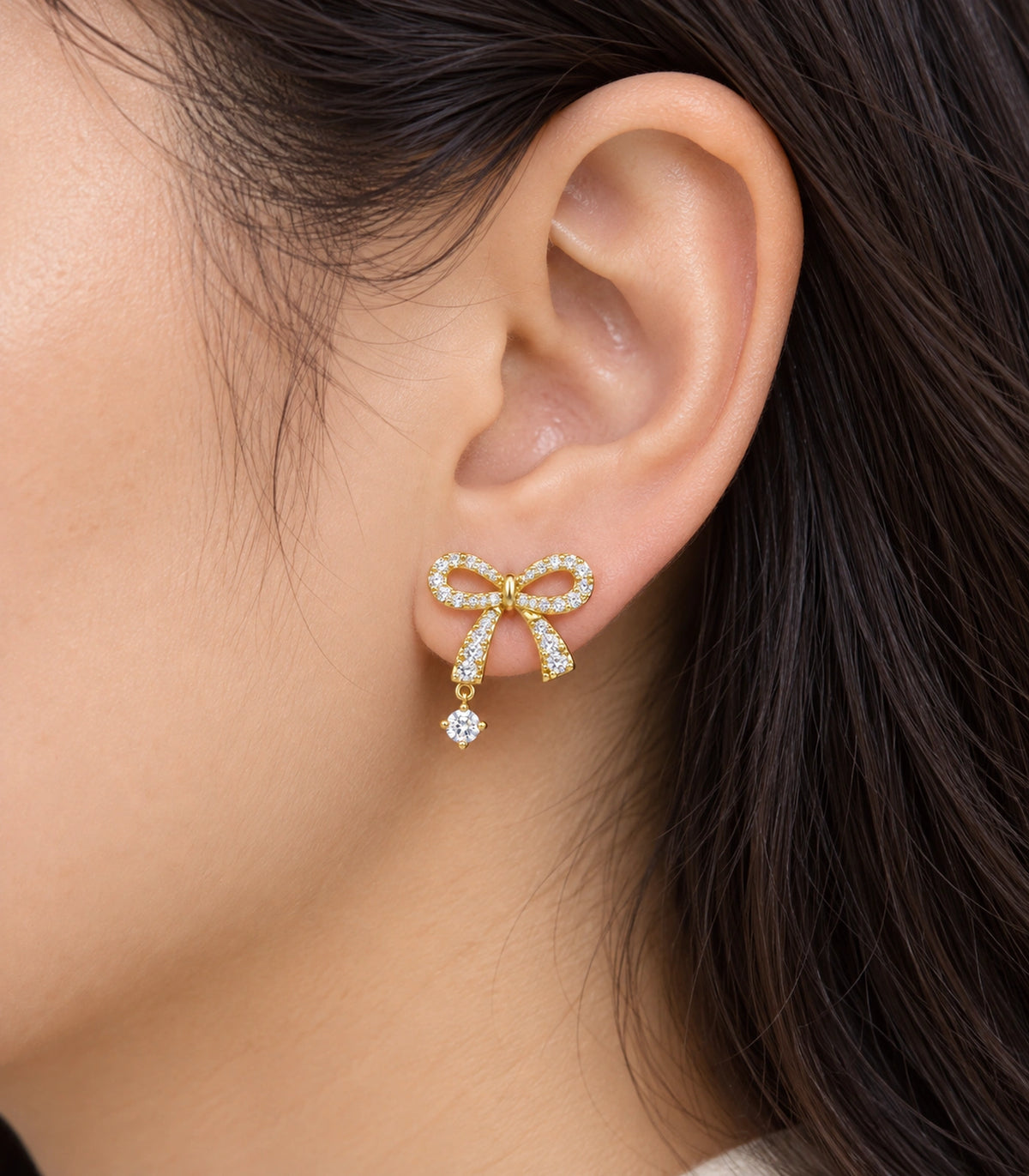 JIMIKI Gold-Tone Asymmetric Crystal Bow Round Drop Stud Earrings in Gold Tone, close-up detail