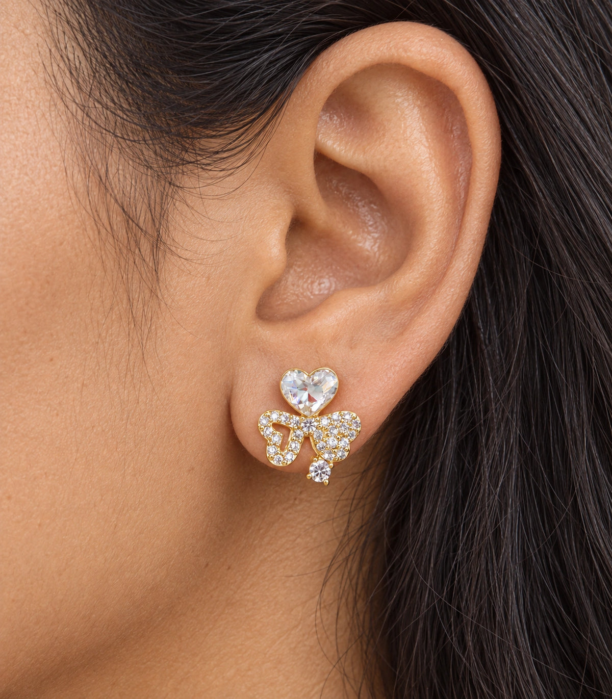 JIMIKI Gold-Tone Asymmetric Crystal Heart Bow Stud Earrings in Gold Tone, close-up detail