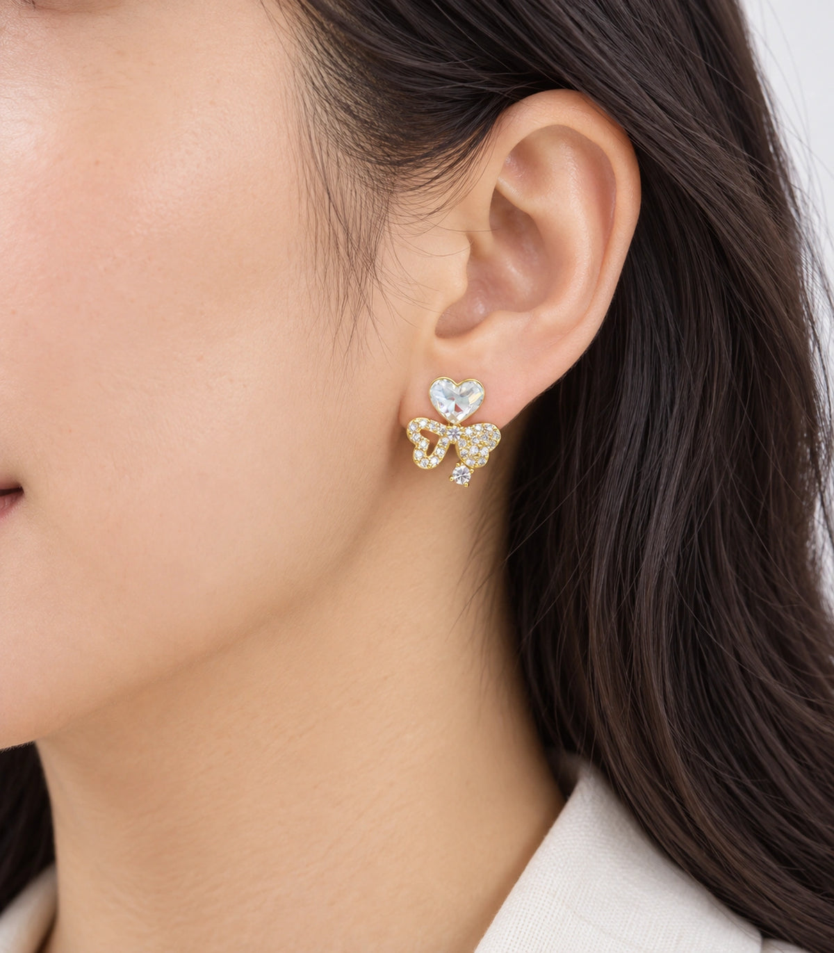 JIMIKI Gold-Tone Asymmetric Crystal Heart Bow Stud Earrings in Gold Tone, model wearing view