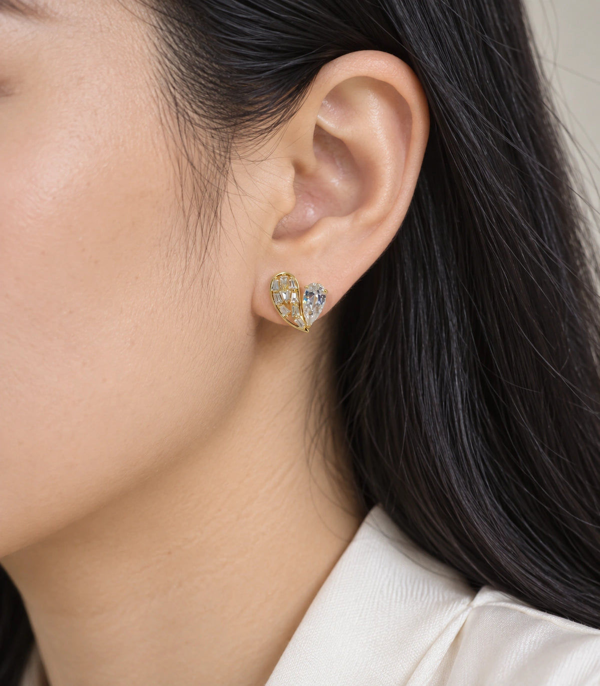 JIMIKI Asymmetric Crystal Heart Stud Earring Pair in Gold Tone, close-up detail #color_gold tone