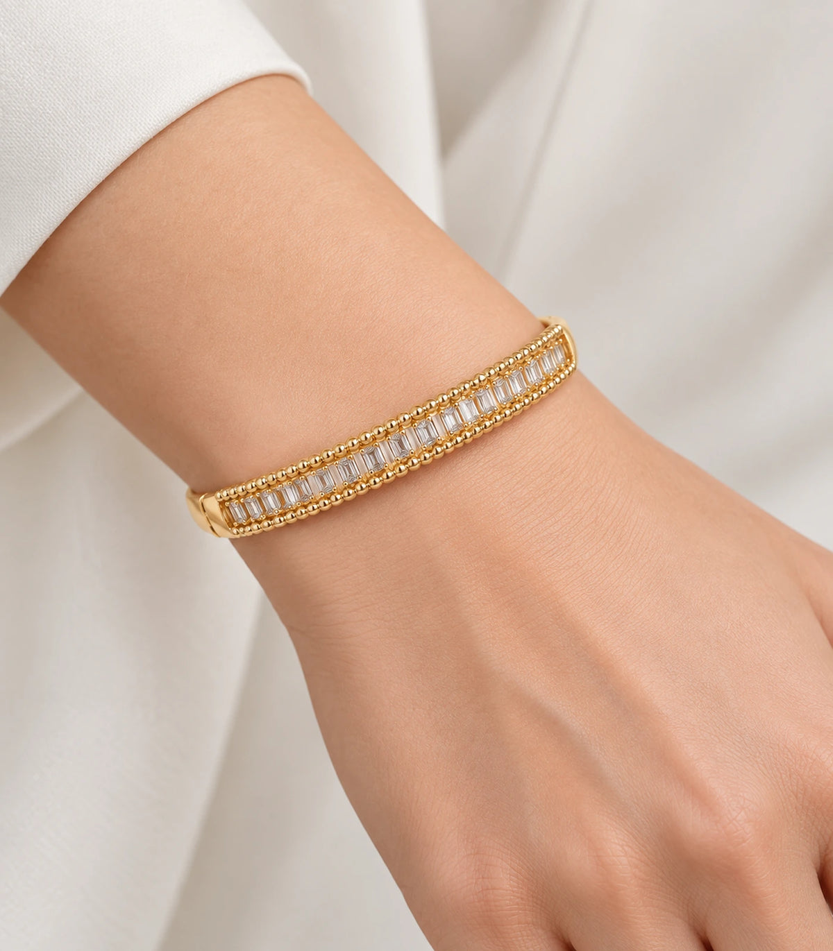 JIMIKI Gold-Tone Baguette Beaded Frame Bangle — worn on the wrist #color_gold-tone / clear