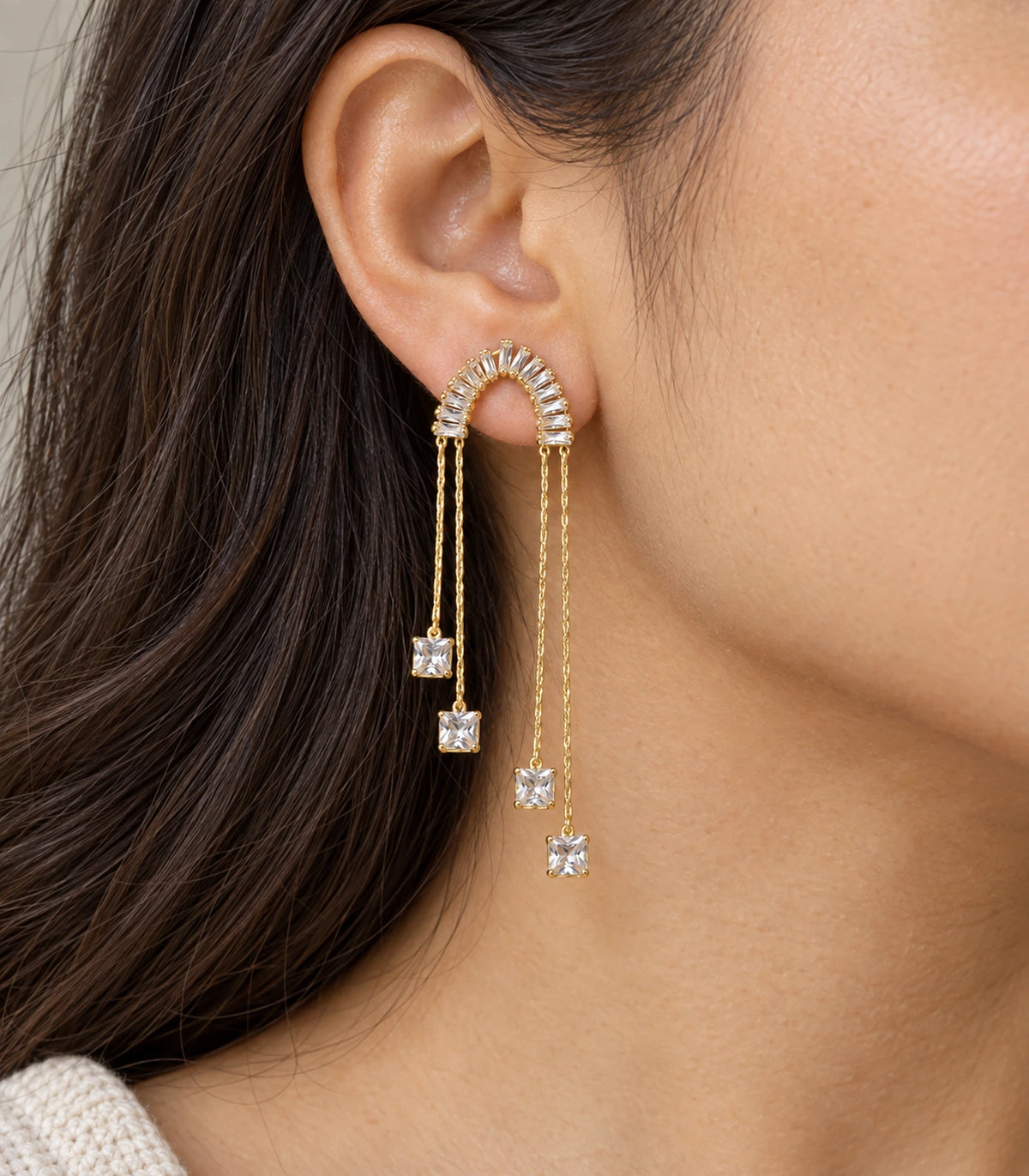 JIMIKI Gold-Tone Crescent Crystal Chain Drop Earrings — close-up of the earring design #color_gold-tone / clear