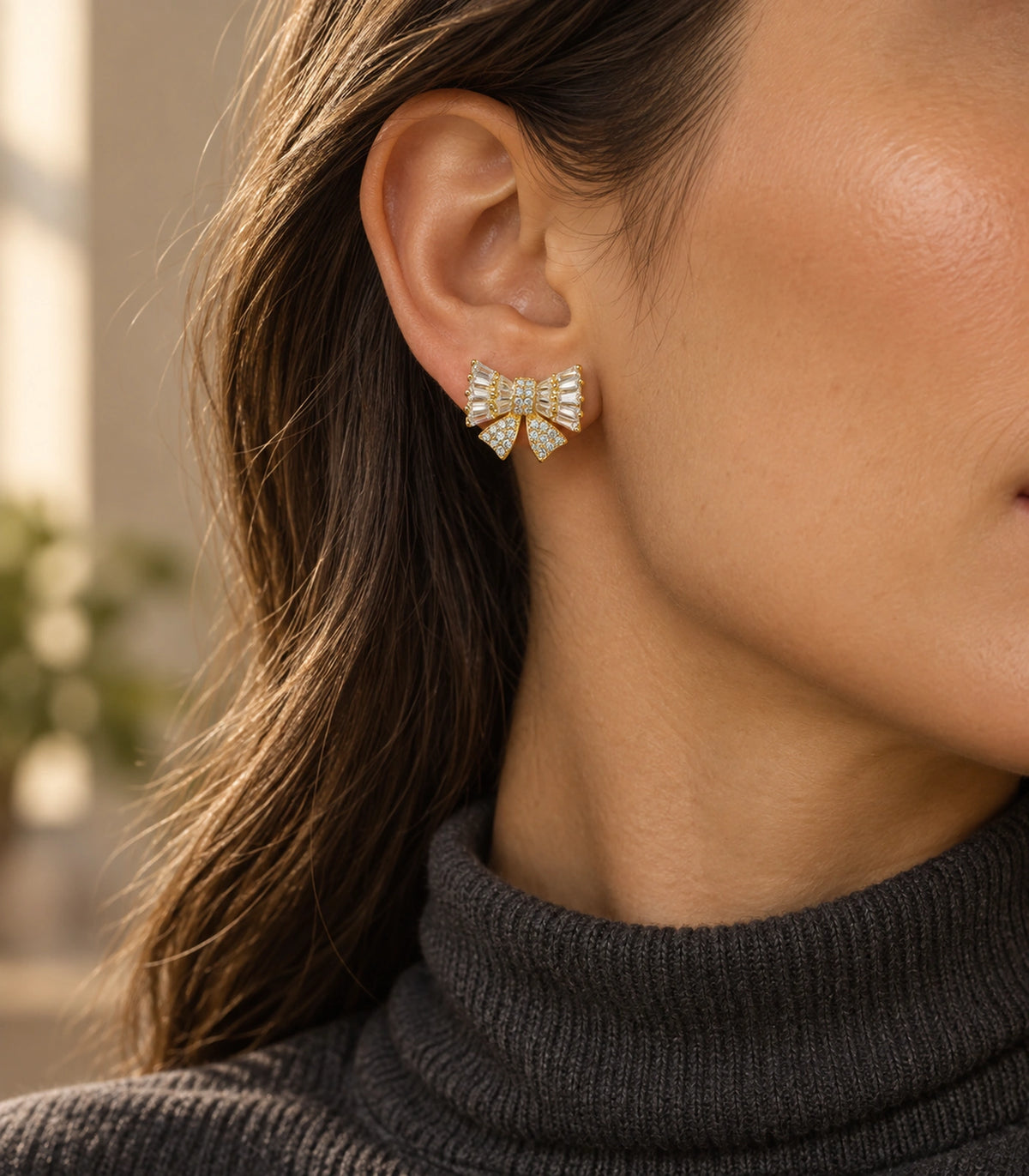 JIMIKI Baguette Crystal Bow Stud Earring Pair in Gold-tone, editorial model view #color_gold-tone
