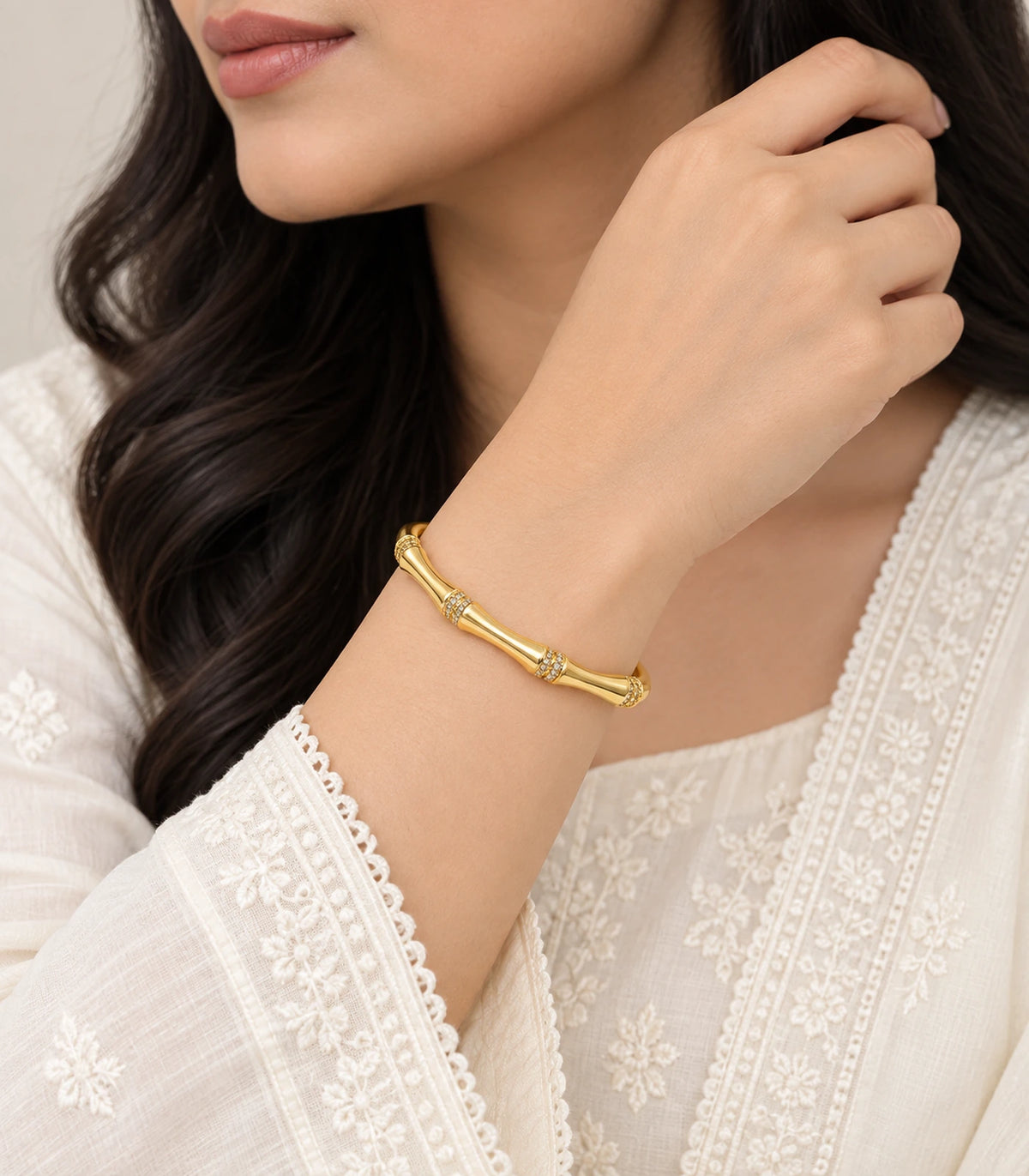 JIMIKI Gold-Tone Bamboo Crystal Collar Bangle — worn on the wrist #color_gold-tone / clear