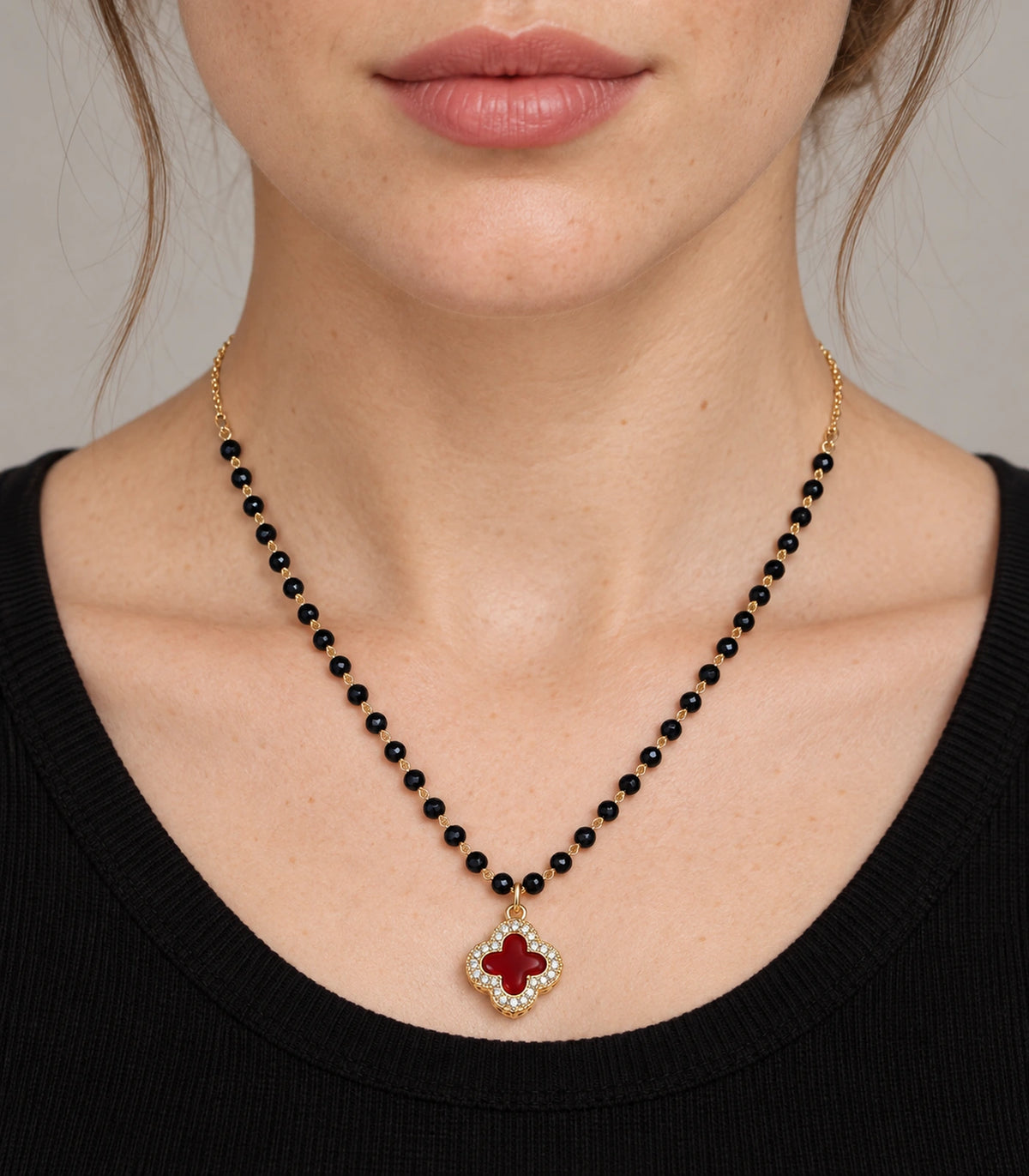 JIMIKI Gold-Tone Black-Bead Red-Quatrefoil Pendant Necklace in Gold Tone / Black / Red - worn styling view #color_gold-tone-black-red