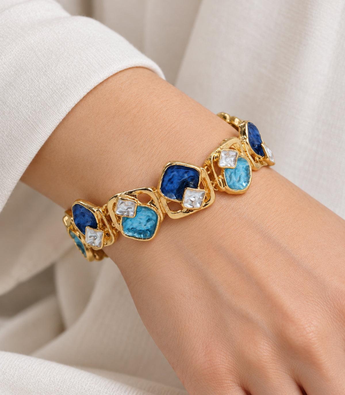 Gold-tone blue geometric openwork bracelet — closeup view