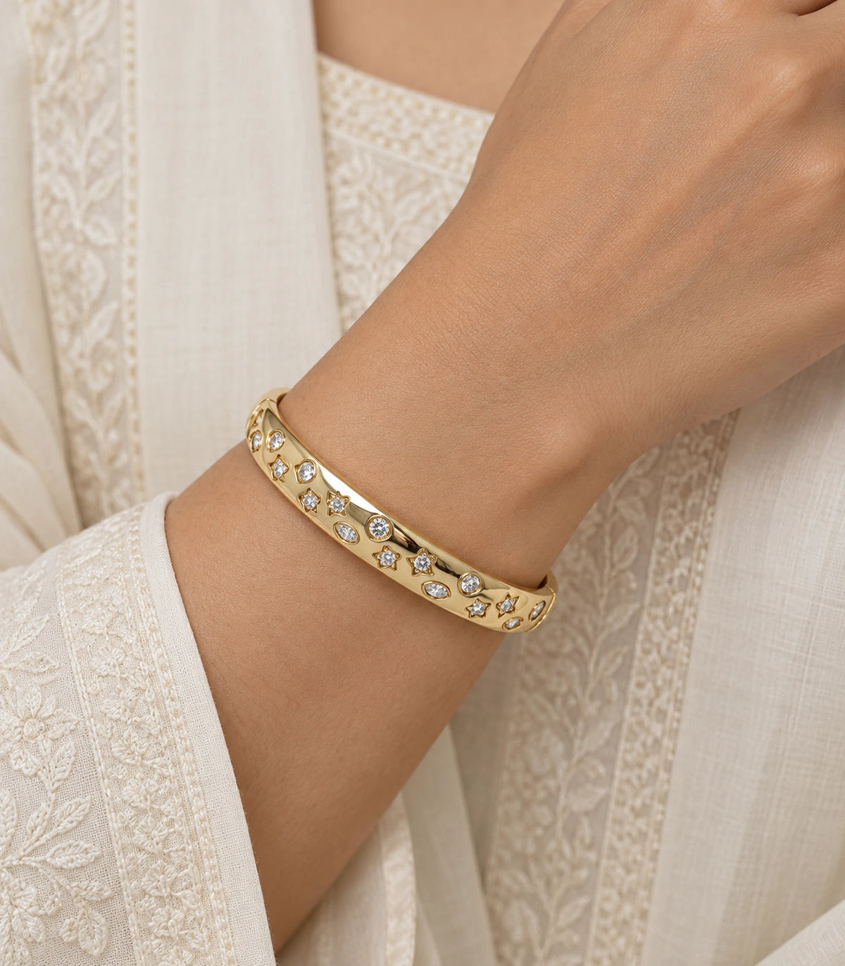 JIMIKI Gold-Tone Celestial Crystal Bangle — worn on the wrist #color_gold-tone / clear