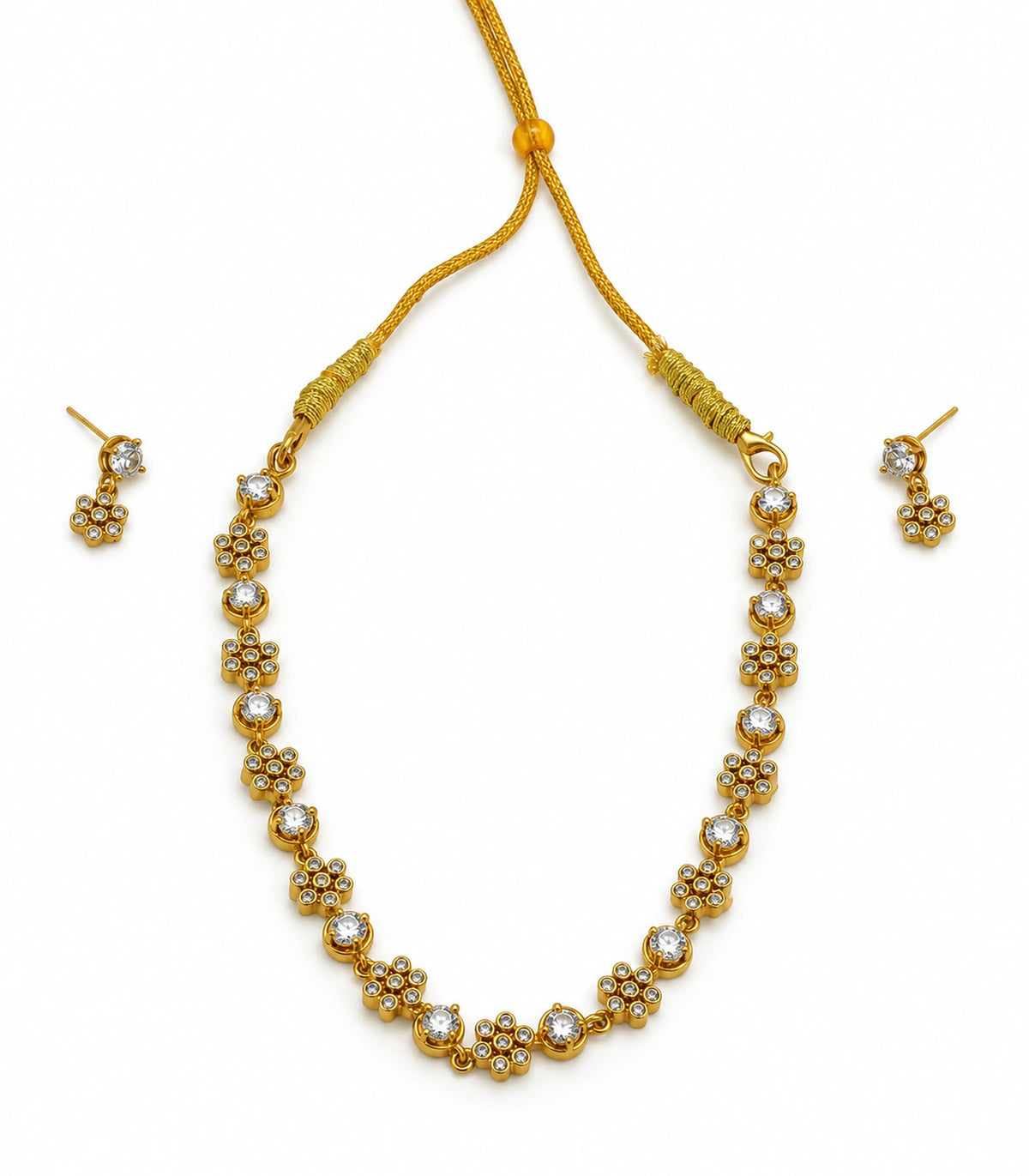 Gold-tone clear crystal-style floral cluster necklace and matching earring pair on white
