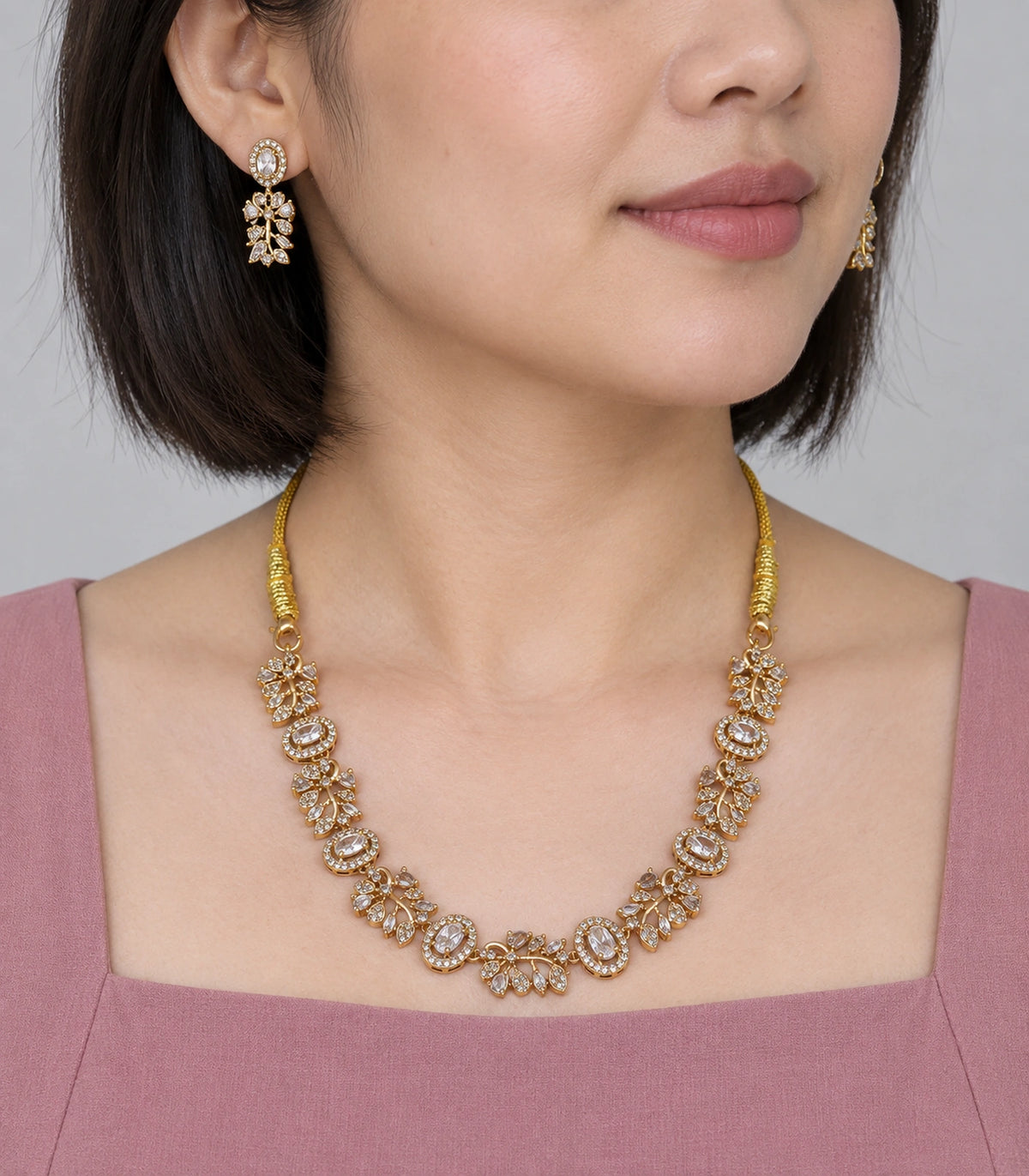 Crystal Floral-Link Necklace Set in Clear Crystal worn with a mauve outfit #Color_Clear Crystal