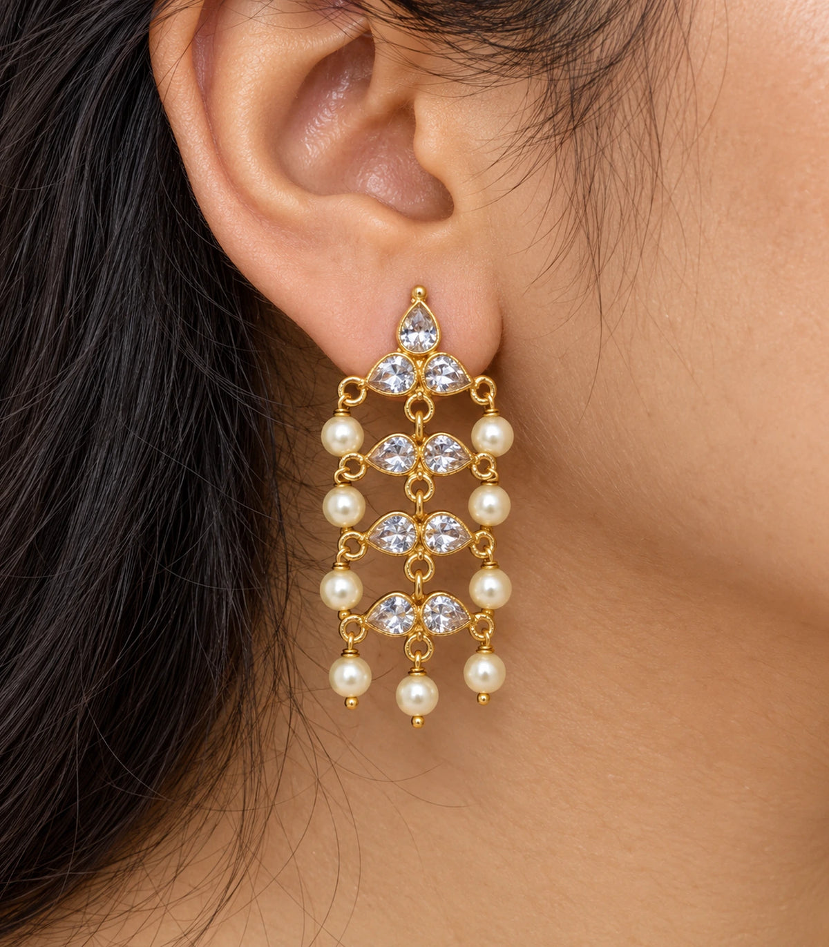 JIMIKI Gold Tone clear-crystal pearl chandelier earrings, worn detail of the design #color_gold-tone