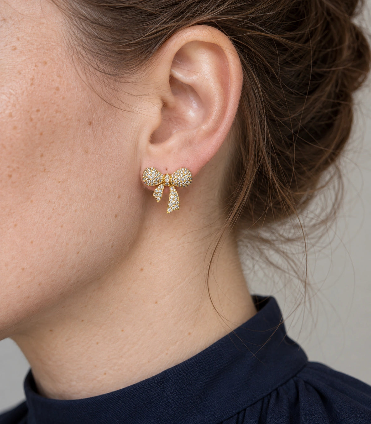 JIMIKI Pave Ribbon Bow Stud Earring Pair in Gold-tone, close-up detail #color_gold-tone