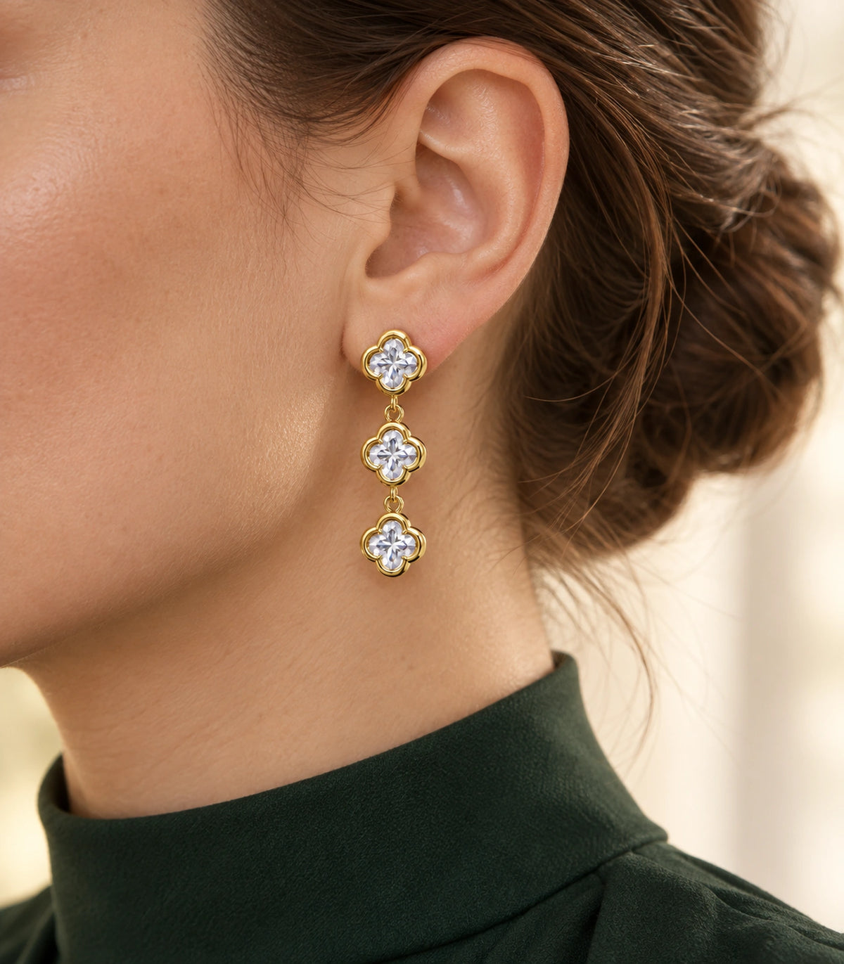 JIMIKI Triple Quatrefoil Crystal Drop Earring Pair in Gold tone / clear, editorial model view #color_gold tone / clear