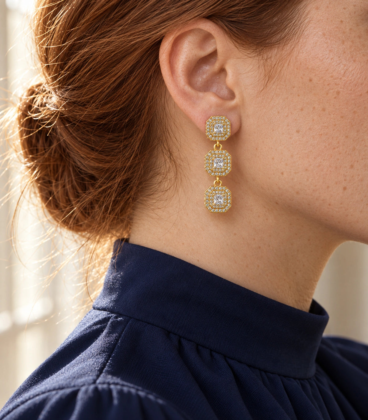 JIMIKI Triple Square Halo Drop Earring Pair in Gold tone / clear, editorial model view #color_gold tone / clear