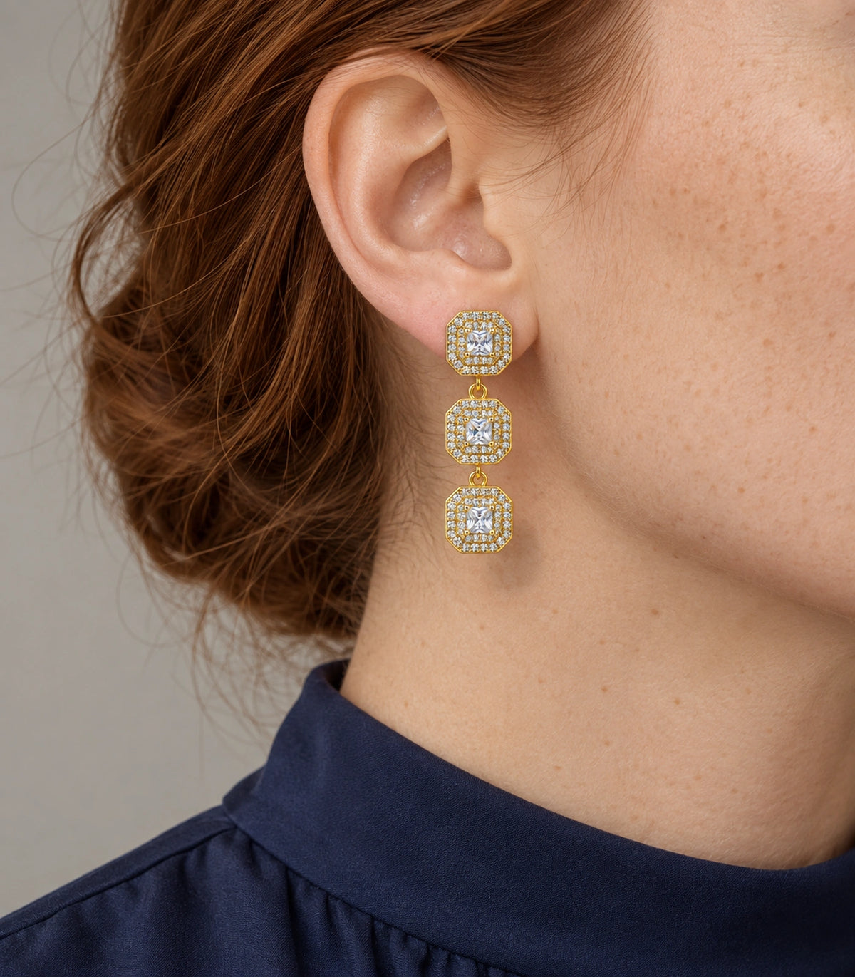 JIMIKI Triple Square Halo Drop Earring Pair in Gold tone / clear, model wearing view #color_gold tone / clear