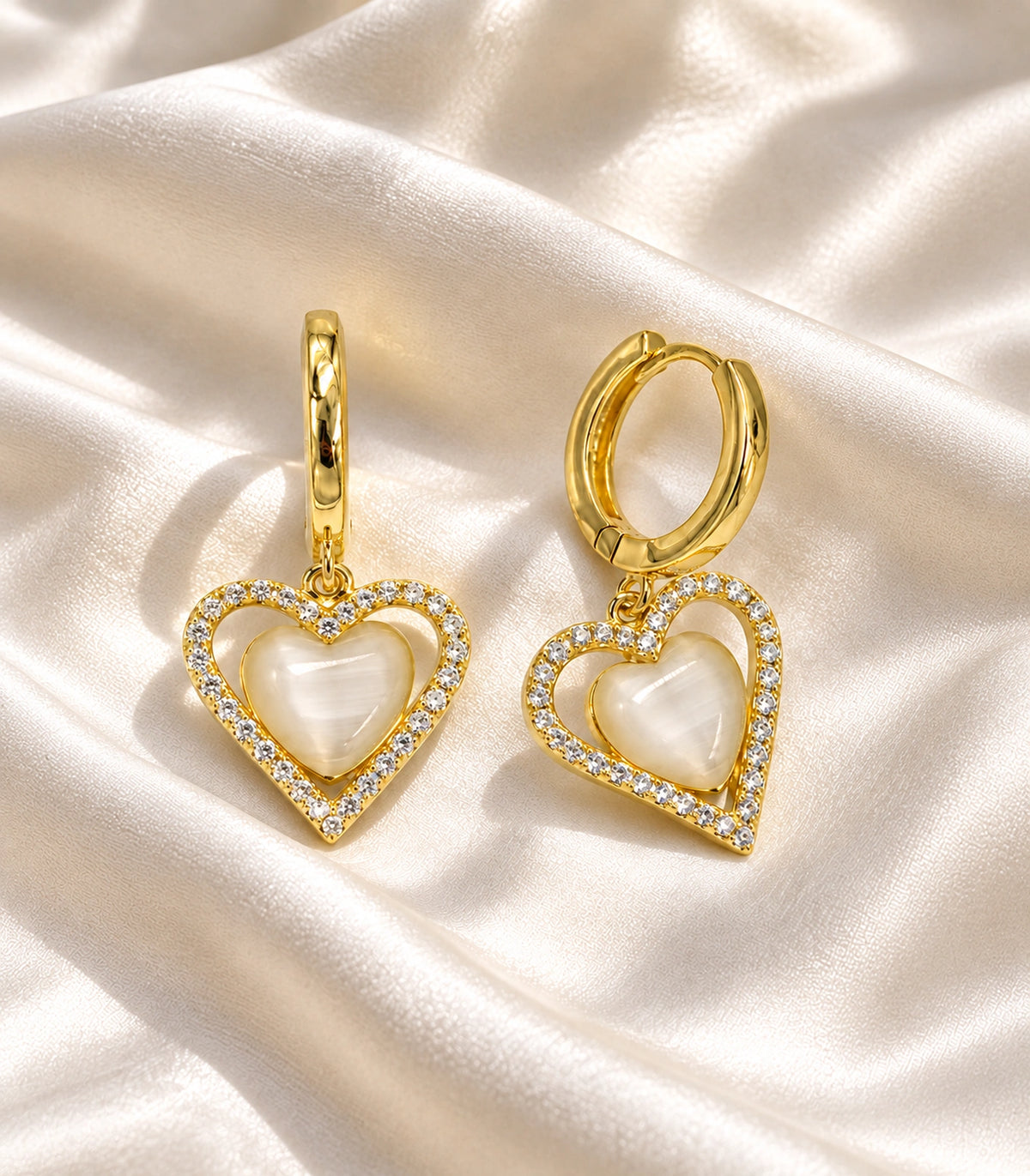 JIMIKI Heart Crystal Frame Drop Hoop Earring Pair in Gold-tone / Cream, editorial flat lay #color_gold-tone / cream
