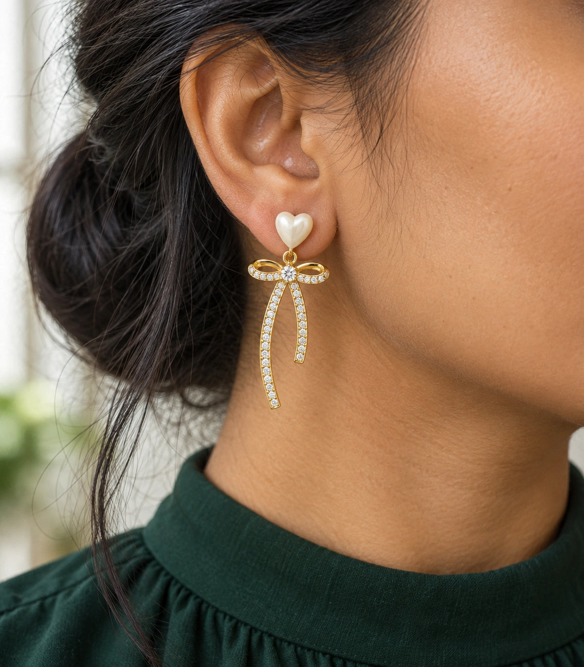 JIMIKI Heart Crystal Ribbon Bow Drop Earring Pair in Gold-tone / Cream, model wearing view #color_gold-tone / cream
