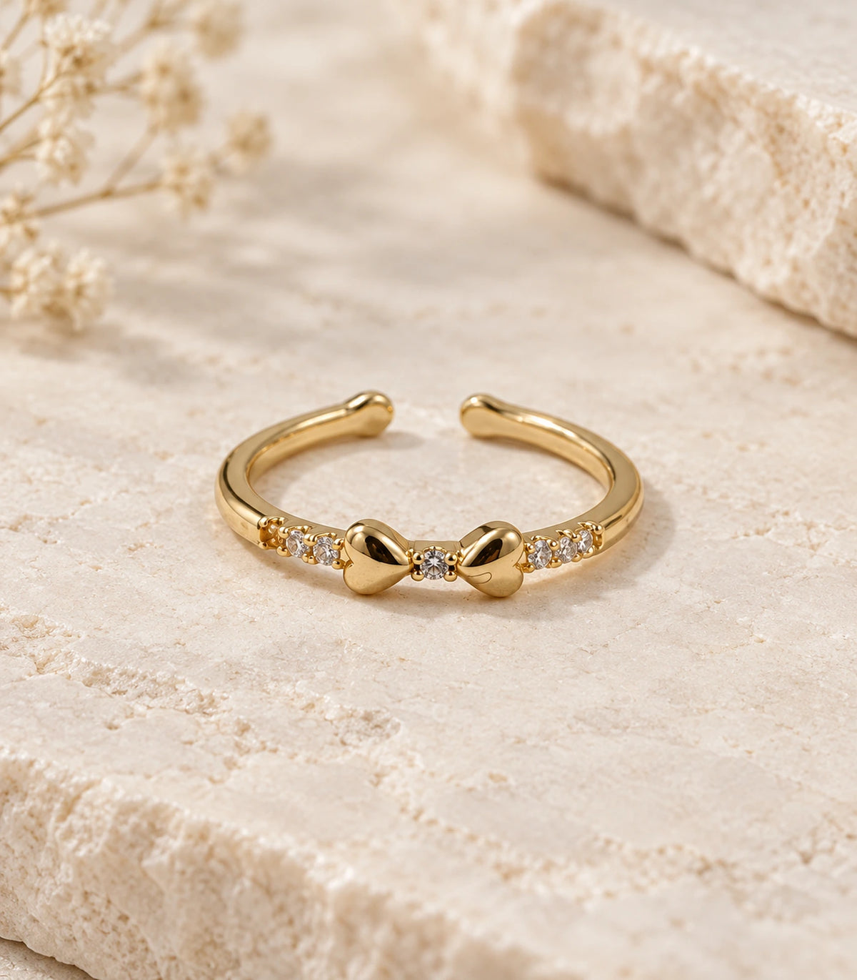 JIMIKI Gold Tone Crystal Bow Ring in Gold Tone - editorial flatlay #color_gold-tone