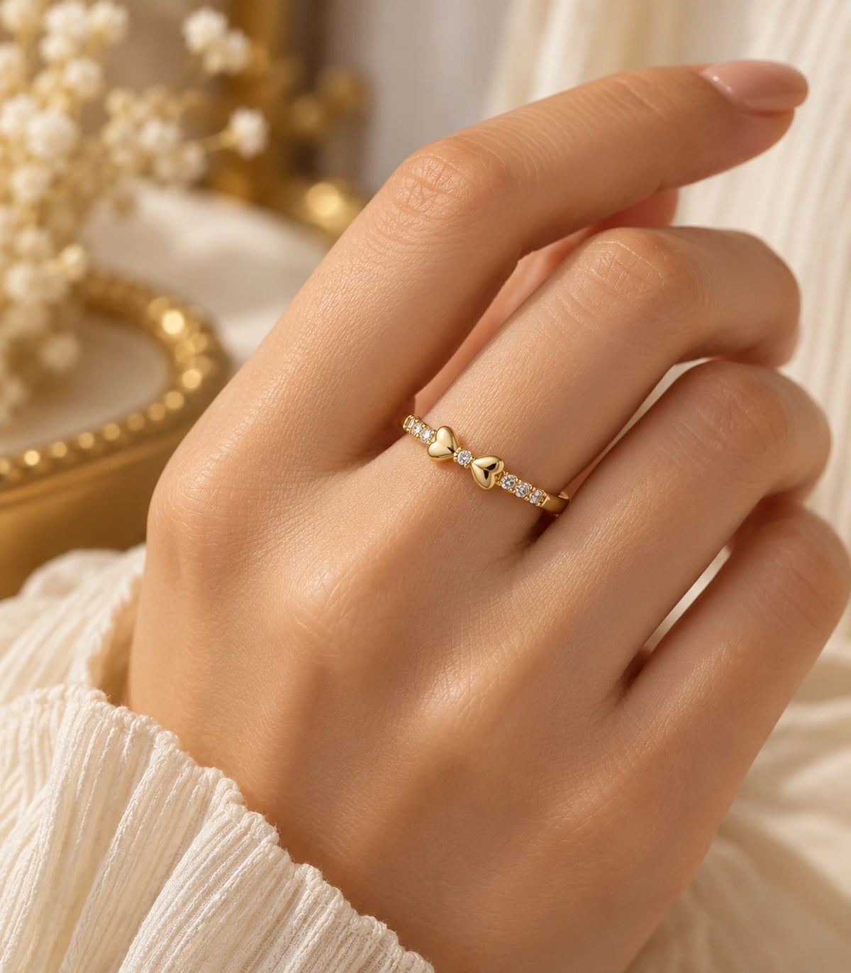 JIMIKI Gold Tone Crystal Bow Ring in Gold Tone - editorial worn view #color_gold-tone