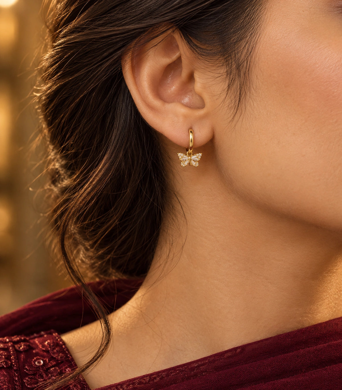 JIMIKI Crystal Butterfly Huggie Earrings in Gold / Clear, editorial model view #color_gold / clear