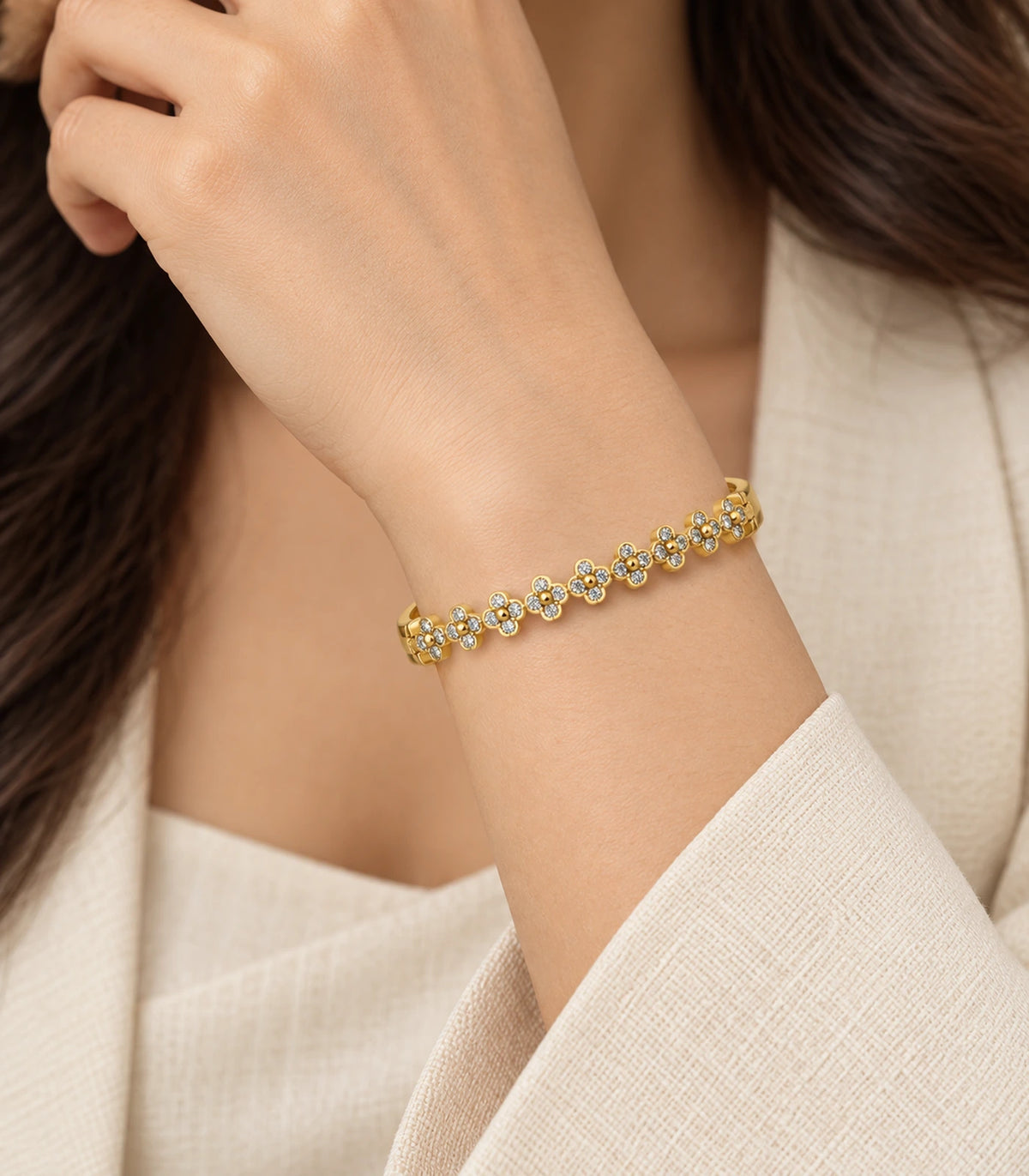 JIMIKI Gold-Tone Crystal Clover Row Bangle — worn on the wrist #color_gold-tone / clear