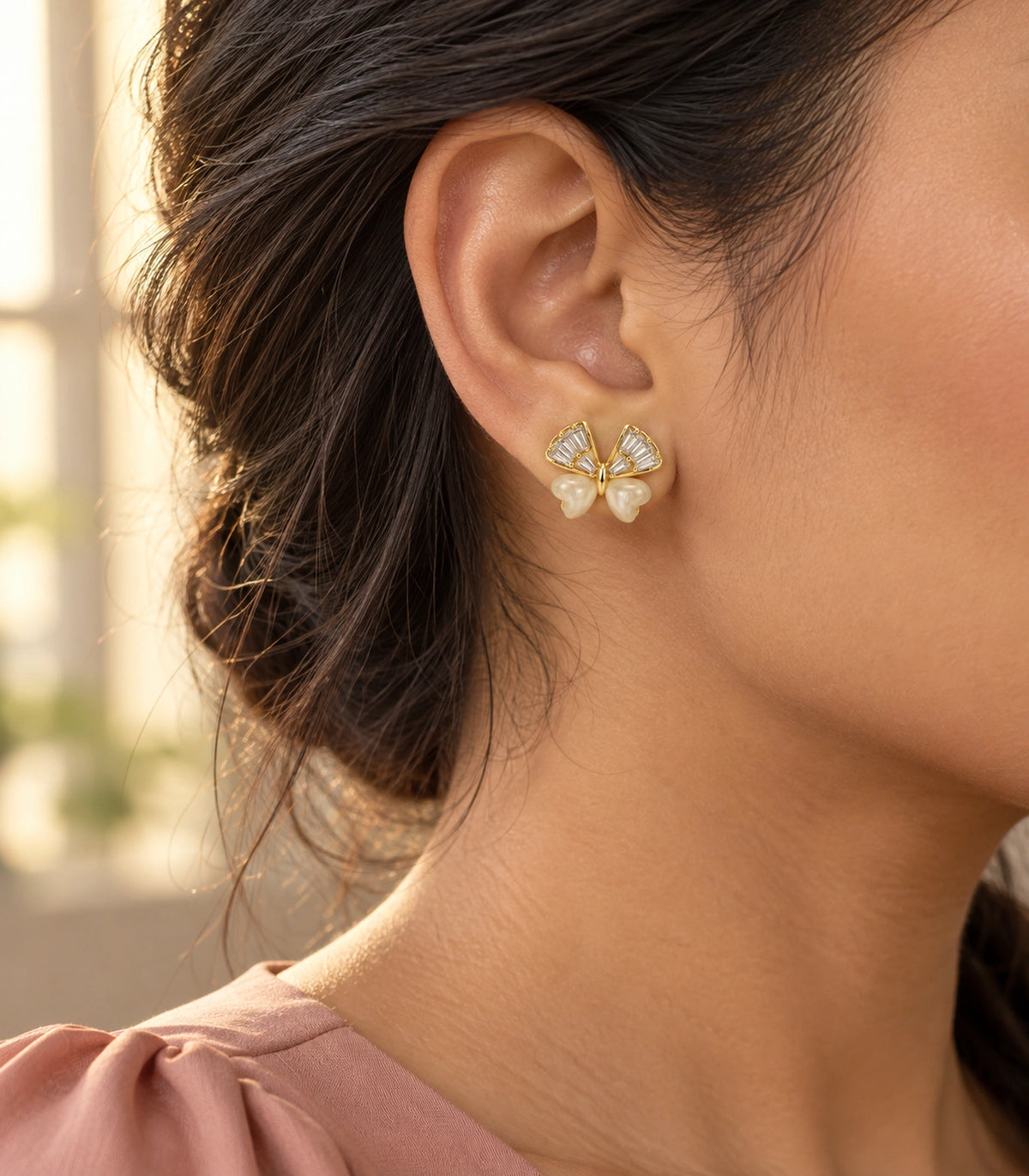 JIMIKI Crystal Wing Butterfly Stud Earring Pair in Gold Tone, editorial model view #color_gold tone